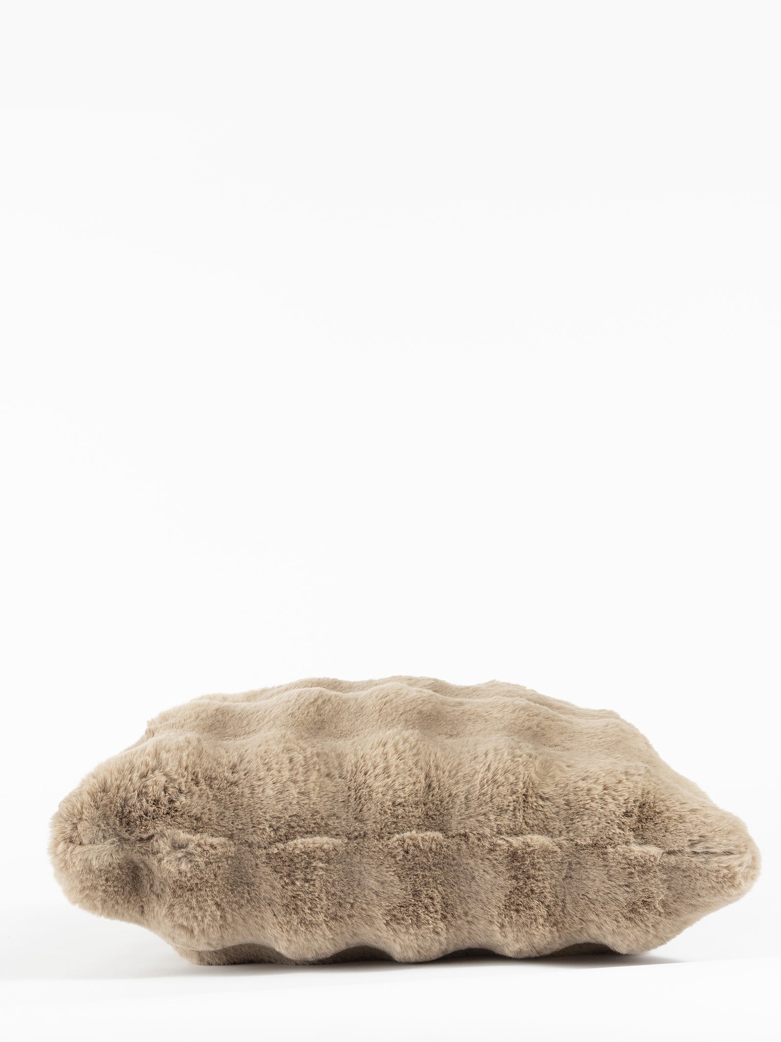 The Bubble Cuddle Pillow by Cozy Earth is displayed against a white background, showcasing its beige, fluffy appearance and inviting, ridged texture. 