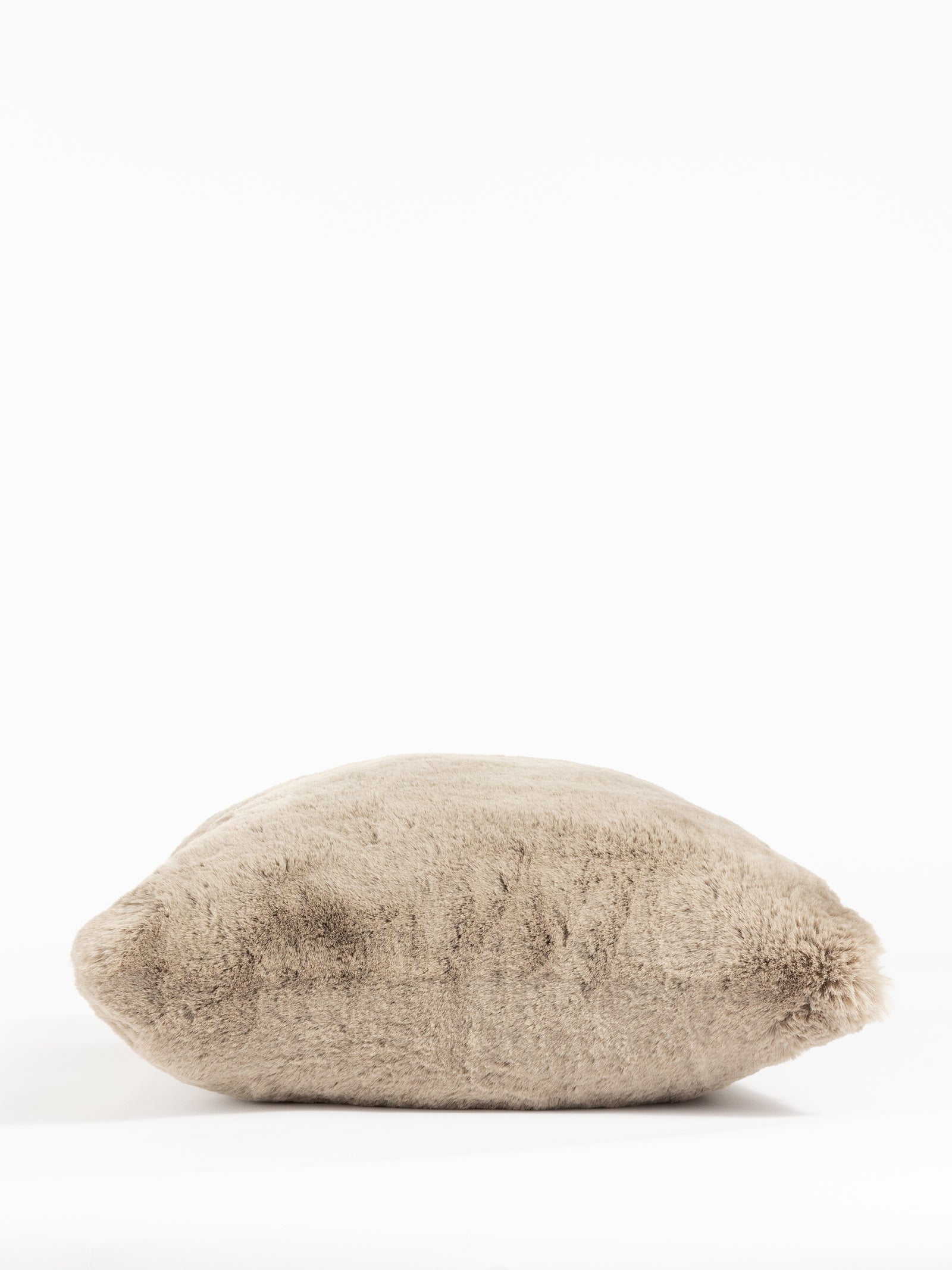 The Cozy Earth Cuddle Pillow is a soft, plush, beige pillow in a rectangular shape set against a white background. Its inviting texture promises comfort and coziness. 