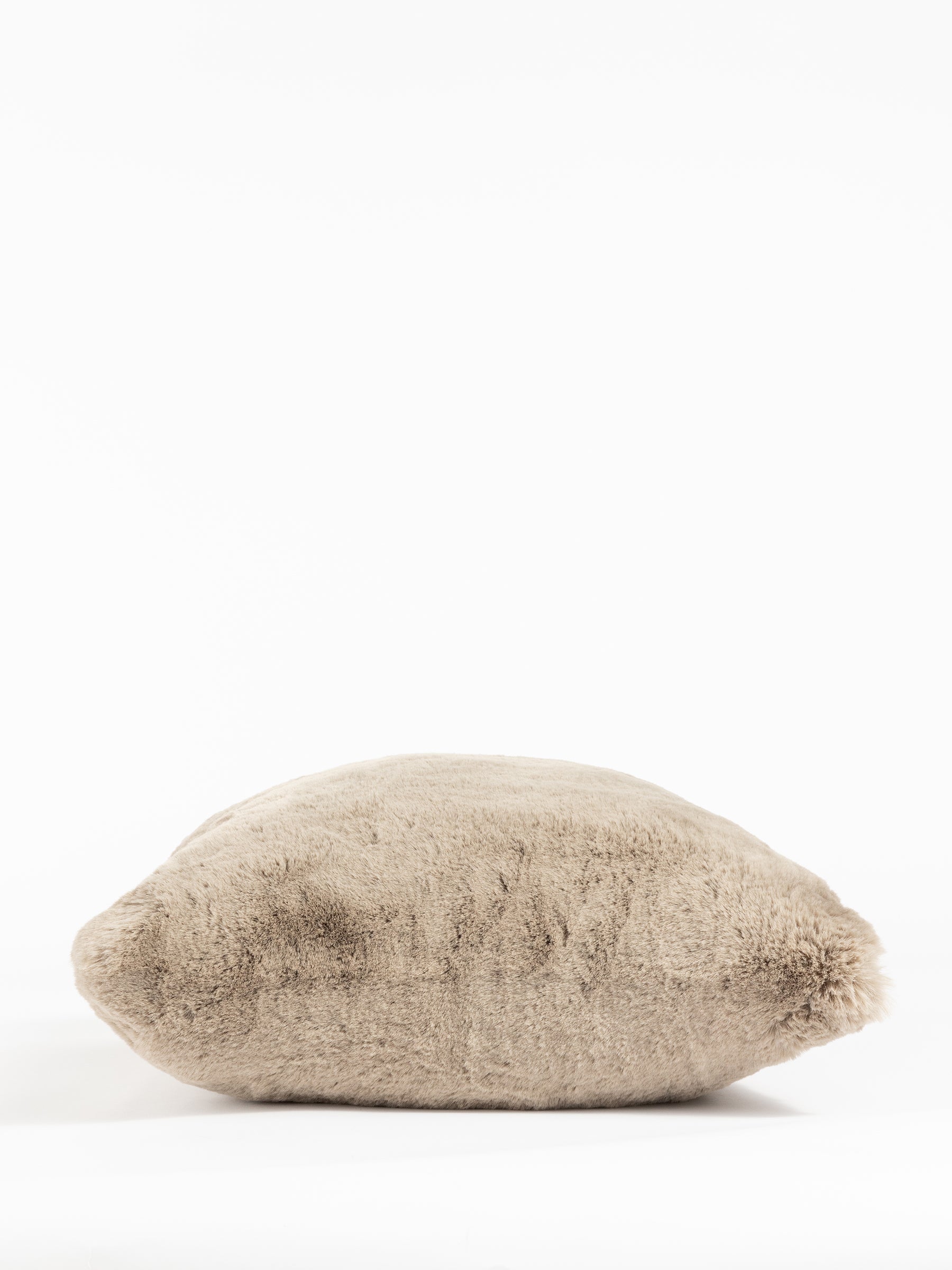 The Cozy Earth Cuddle Pillow is a soft, plush, beige pillow in a rectangular shape set against a white background. Its inviting texture promises comfort and coziness. |Color:Walnut