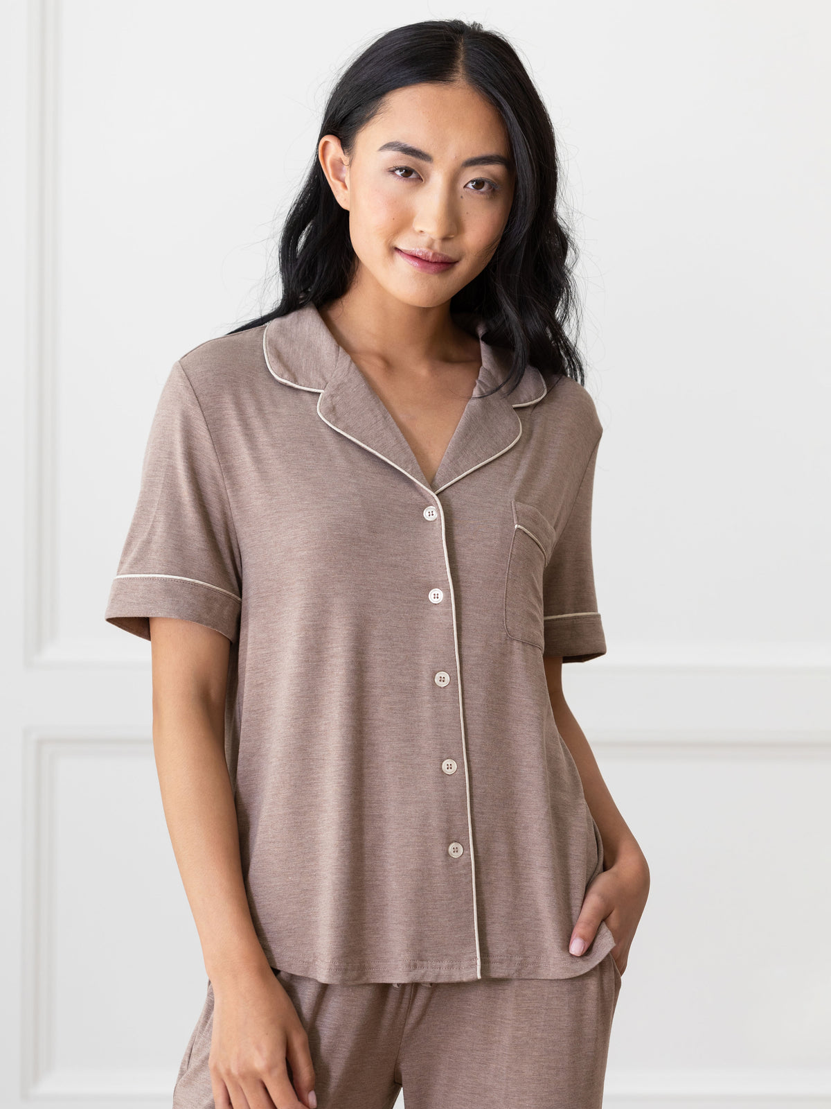 Walnut Short Sleeve & Pant Bamboo Pajama Set modeled by a woman. The photo was taken in a high contrast setting, showing off the colors and lines of the pajamas. 