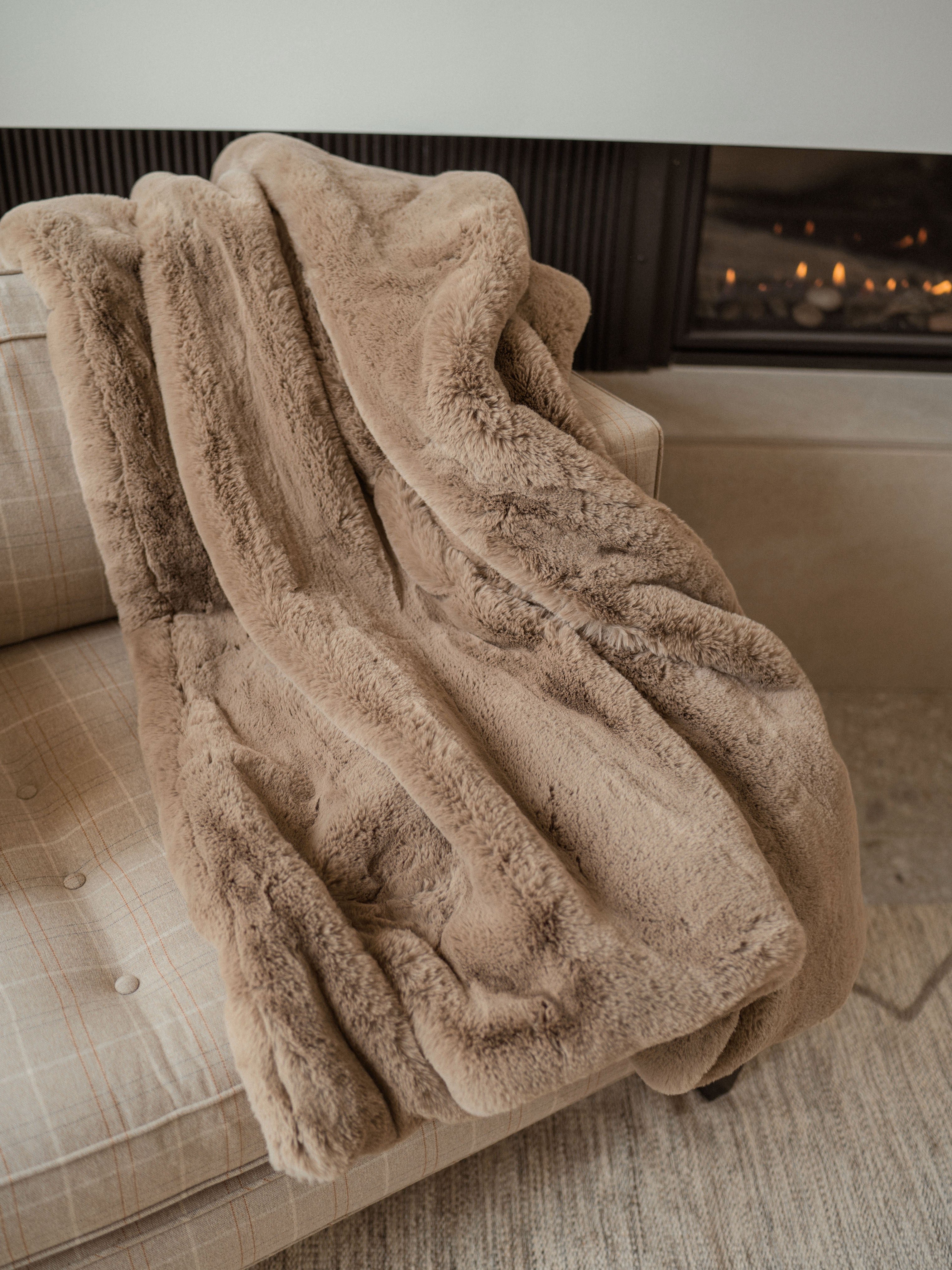 Walnut Oversized Throw Cuddle Blanket on the couch by the fireplace 
