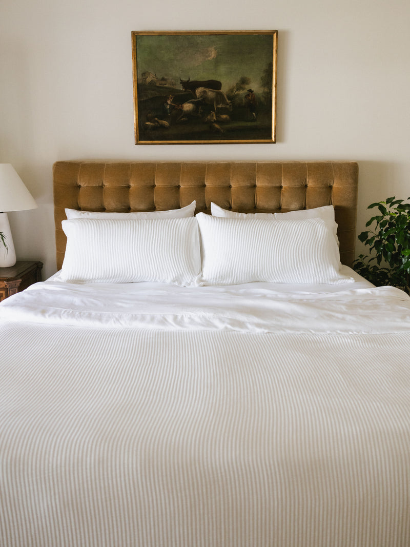 White coverlet and shams on a bed