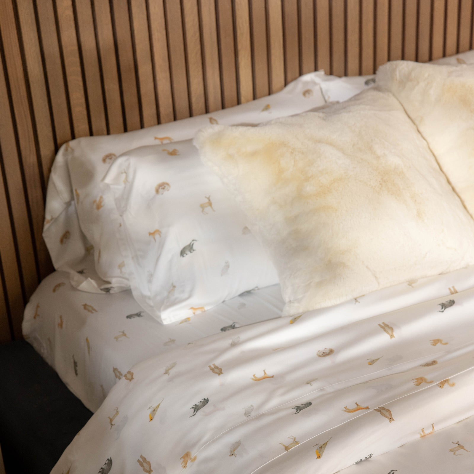 Bed made with sheets with woodland creatures on them standard/king/body