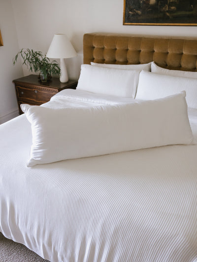 Body pillow laying on the middle of white bed |Size:Body