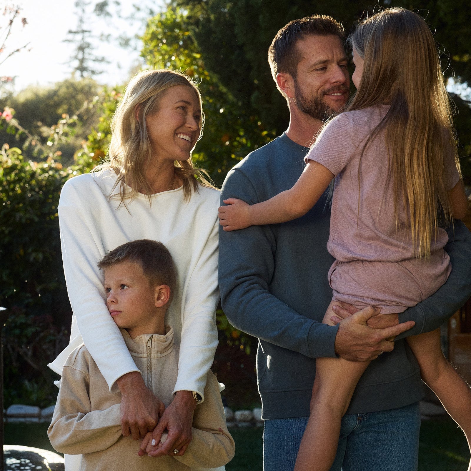 Family of four outdoors in a natural setting