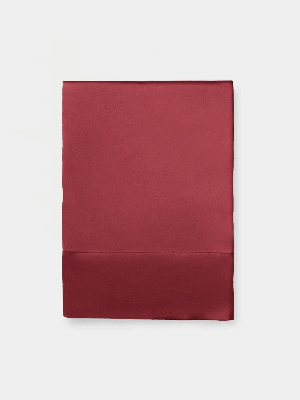Flat lay of wine silk pillowcase with white background 