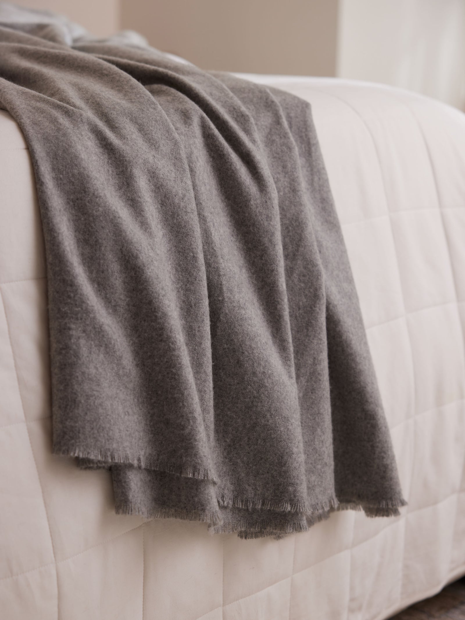 Close up of cashmere blanket on bed 
