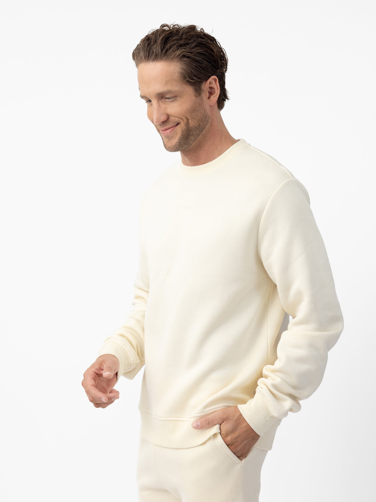 Man wearing Alabaster cityscape crewneck with white background 