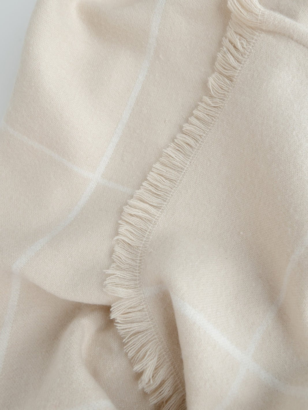 Close up of beige windowpane blanket 