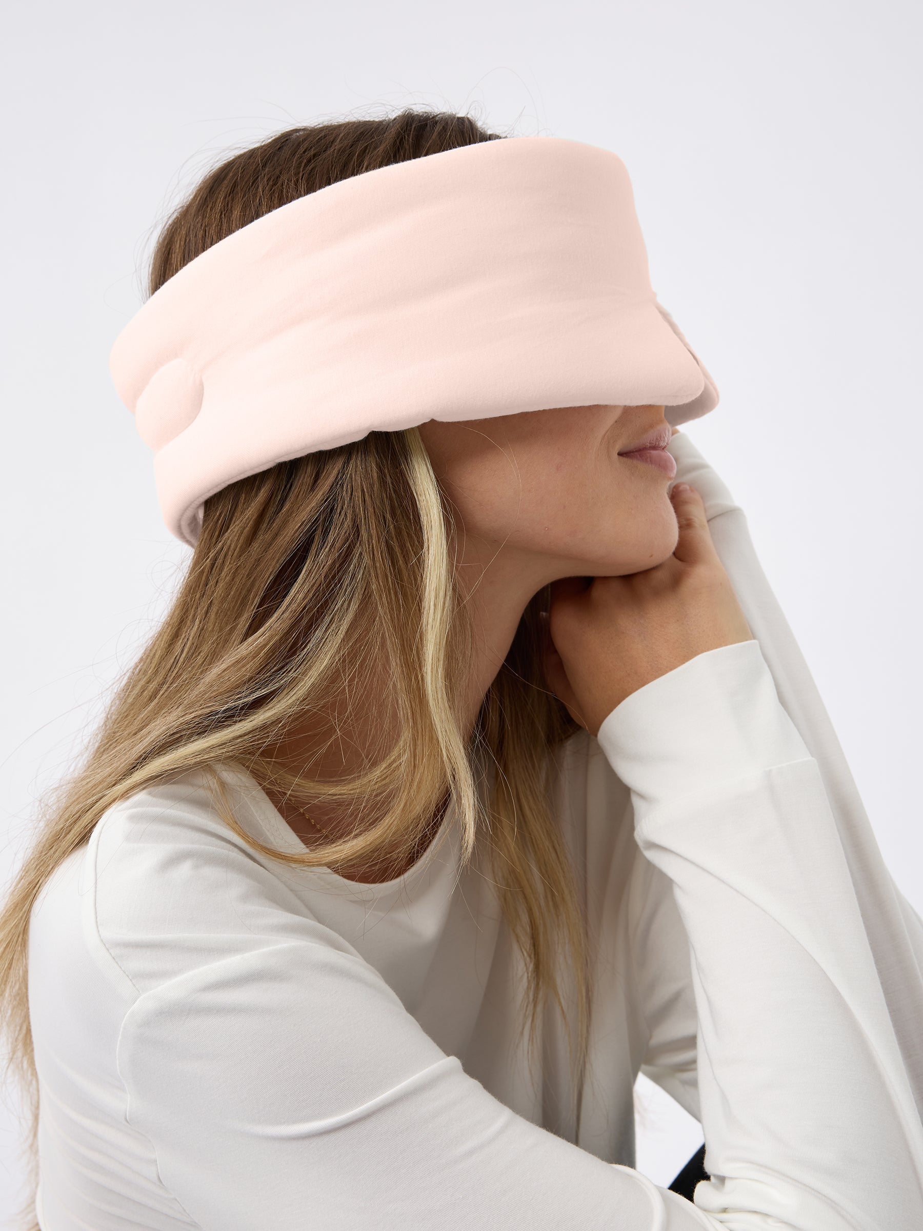 A woman turned to the side wears the Cozy Earth Adjustable Bamboo Sleep Mask in Blossom. |Color:Blossom