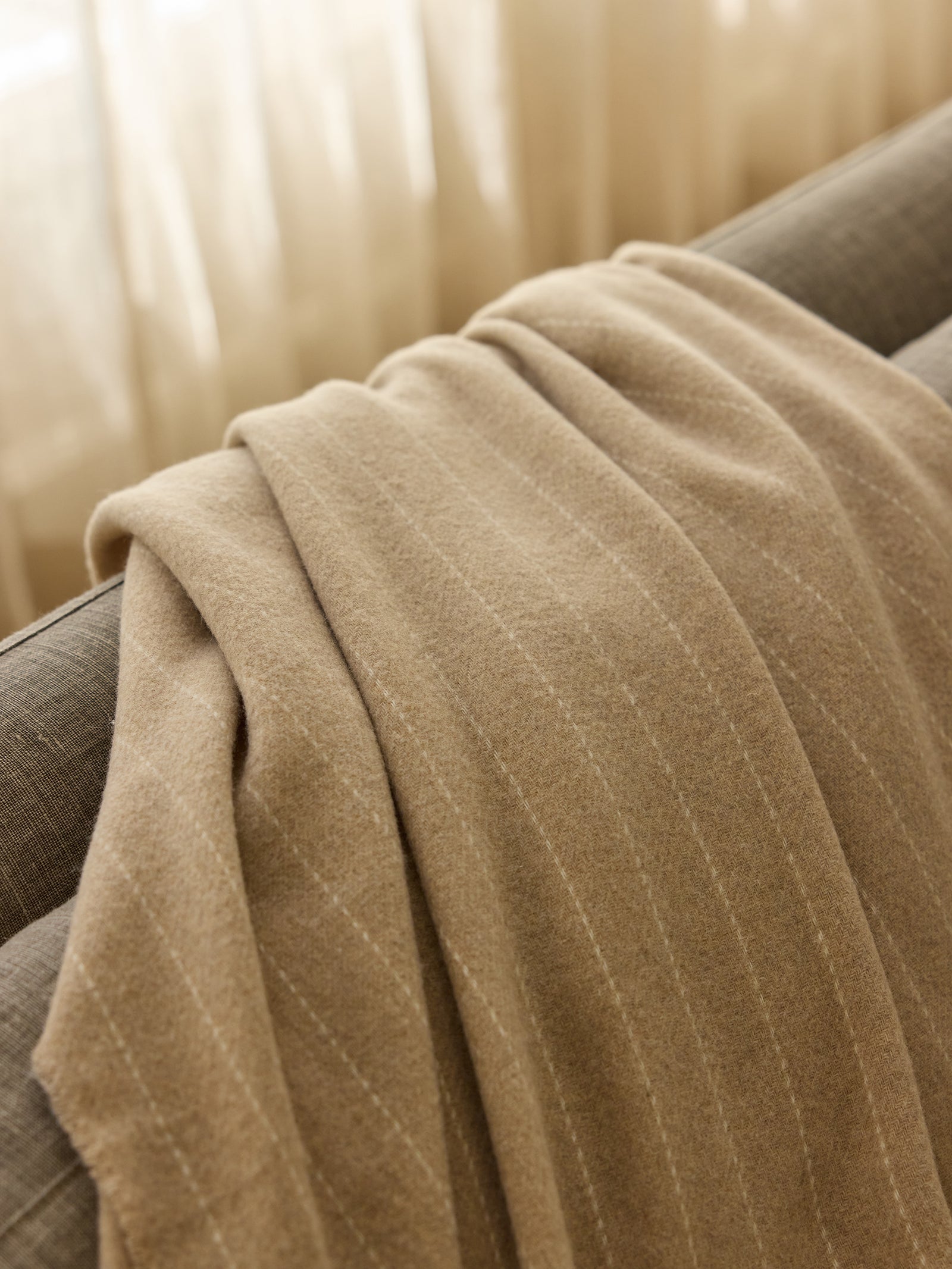 Close up of brandy florence throw laying on sofa 