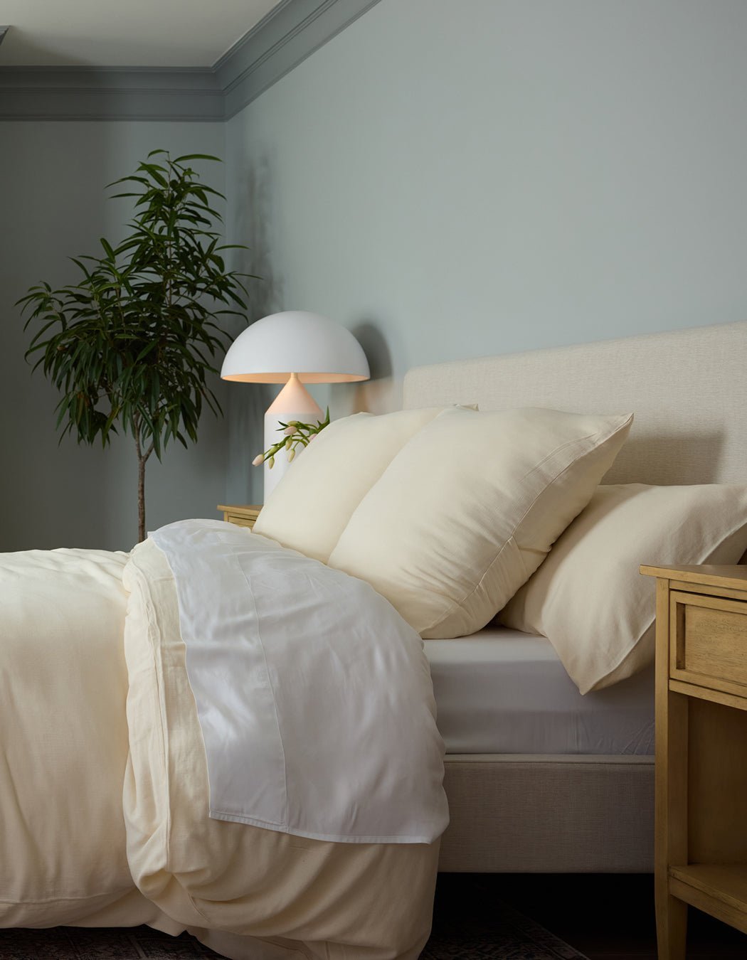Buttermilk Aire Bamboo Shams. The shams are resting on a bed in a bedroom