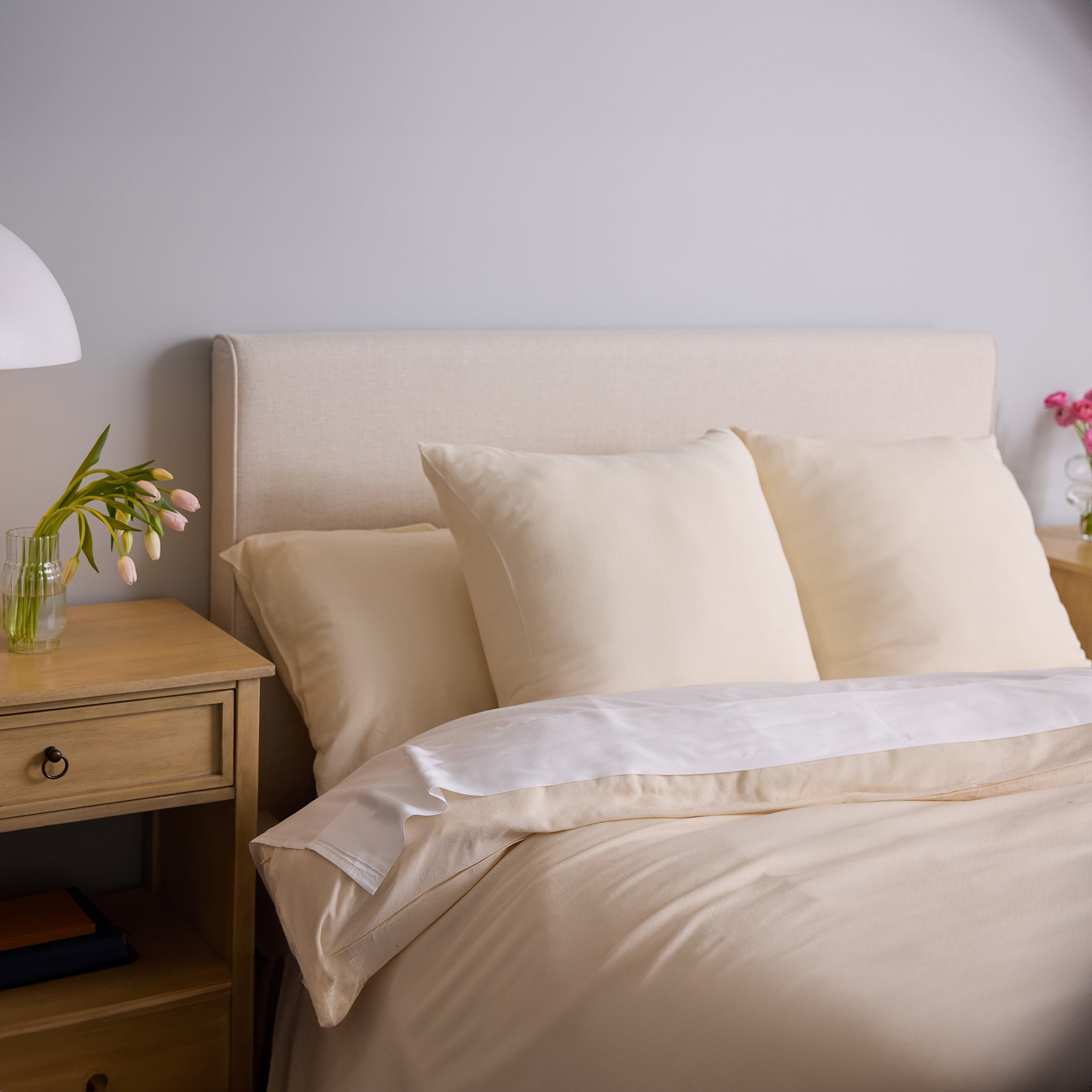 Buttermilk Aire Bamboo Shams. The shams are resting on a bed in a bedroom