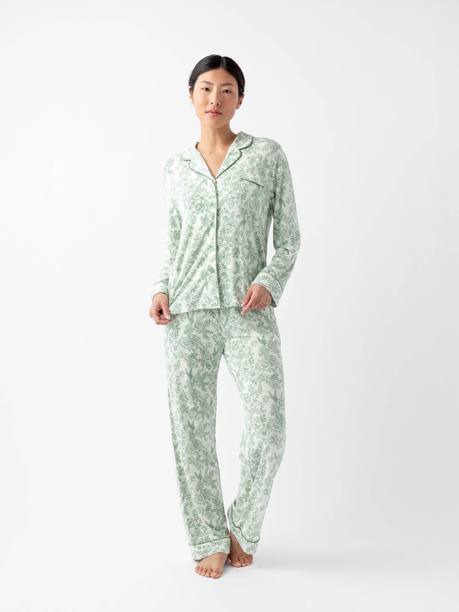 Woman standing in celadon toile pajama set with white background 