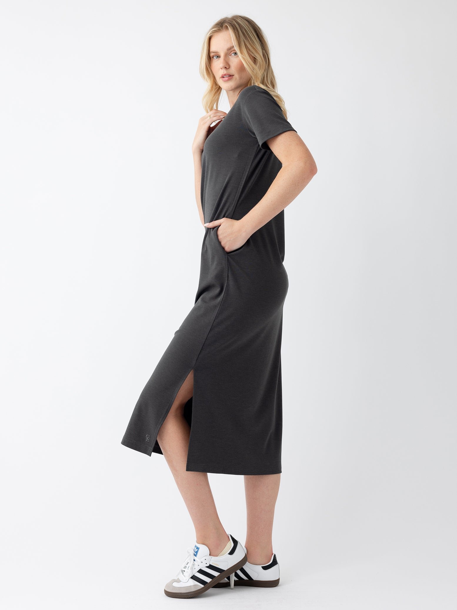 Woman in charcoal midi dress with white background 