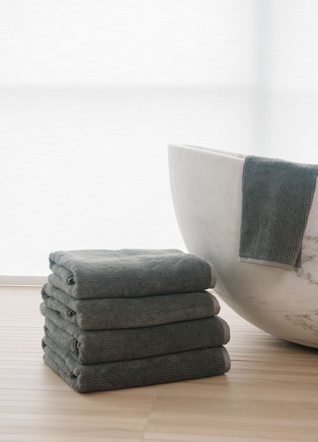 Complete Ribbed Terry Bath Bundle in the color Charcoal. Photo of Complete Ribbed Terry Bath Bundle taken in a bathroom next to a bathtub. 