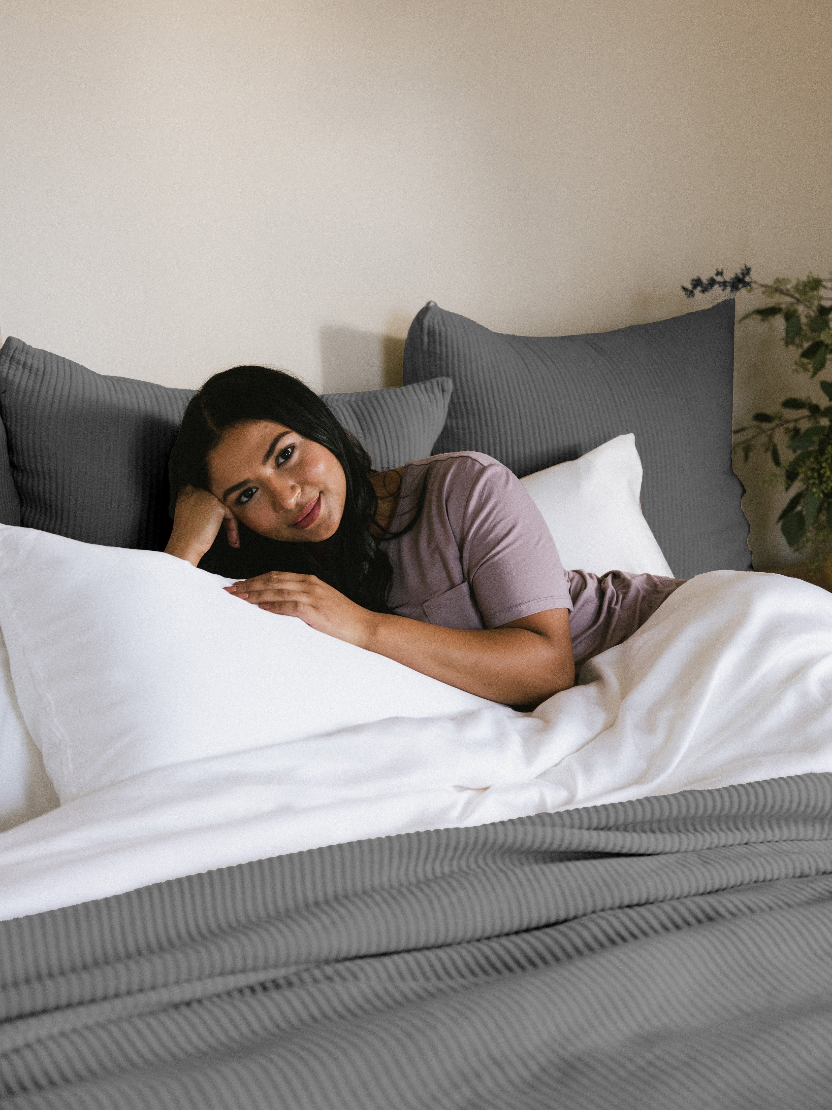 Woman laying in bed with charcoal shams and coverlet |Color:Charcoal