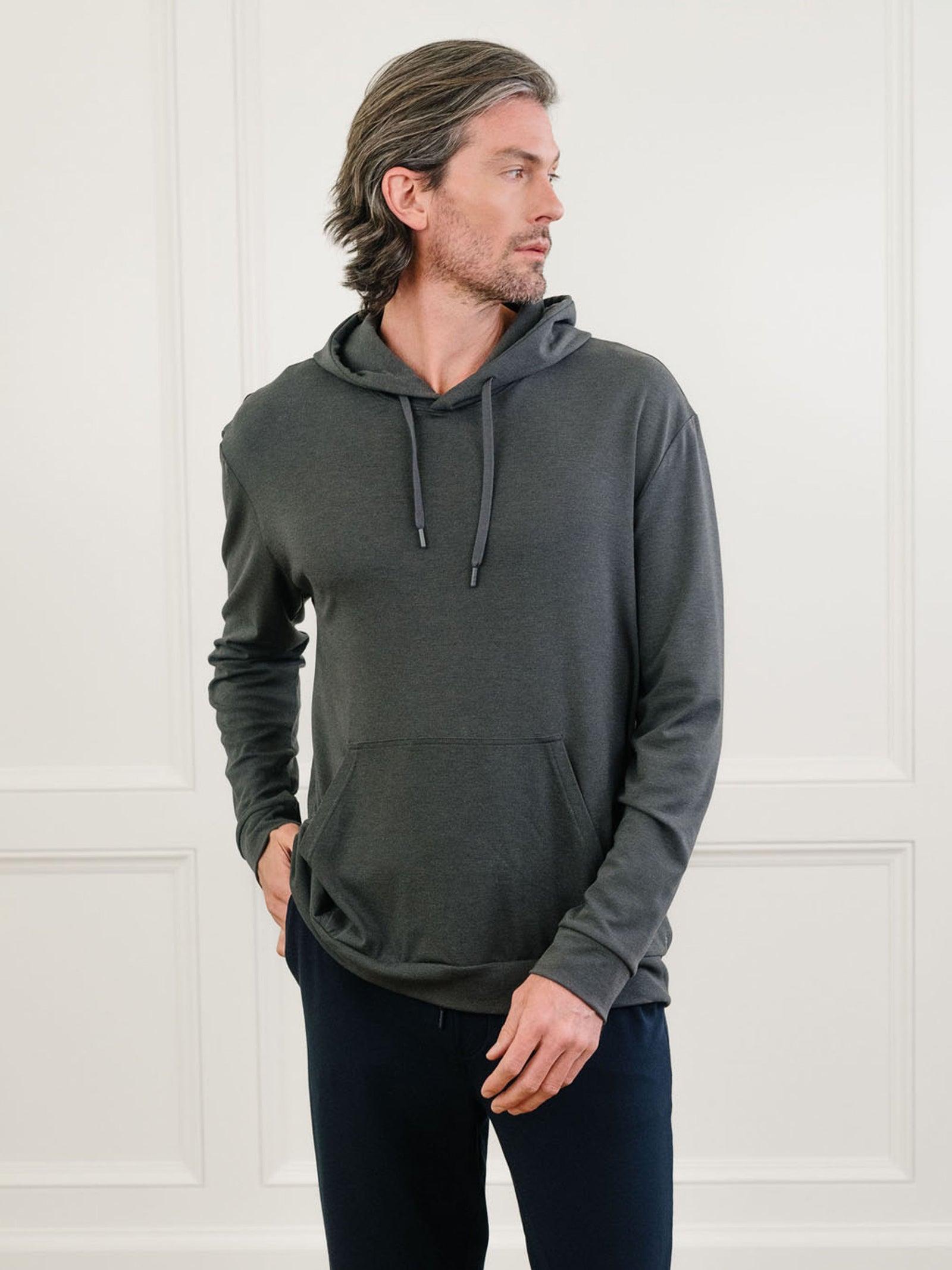 Charcoal Bamboo Hoodie worn by man standing in front of white background.