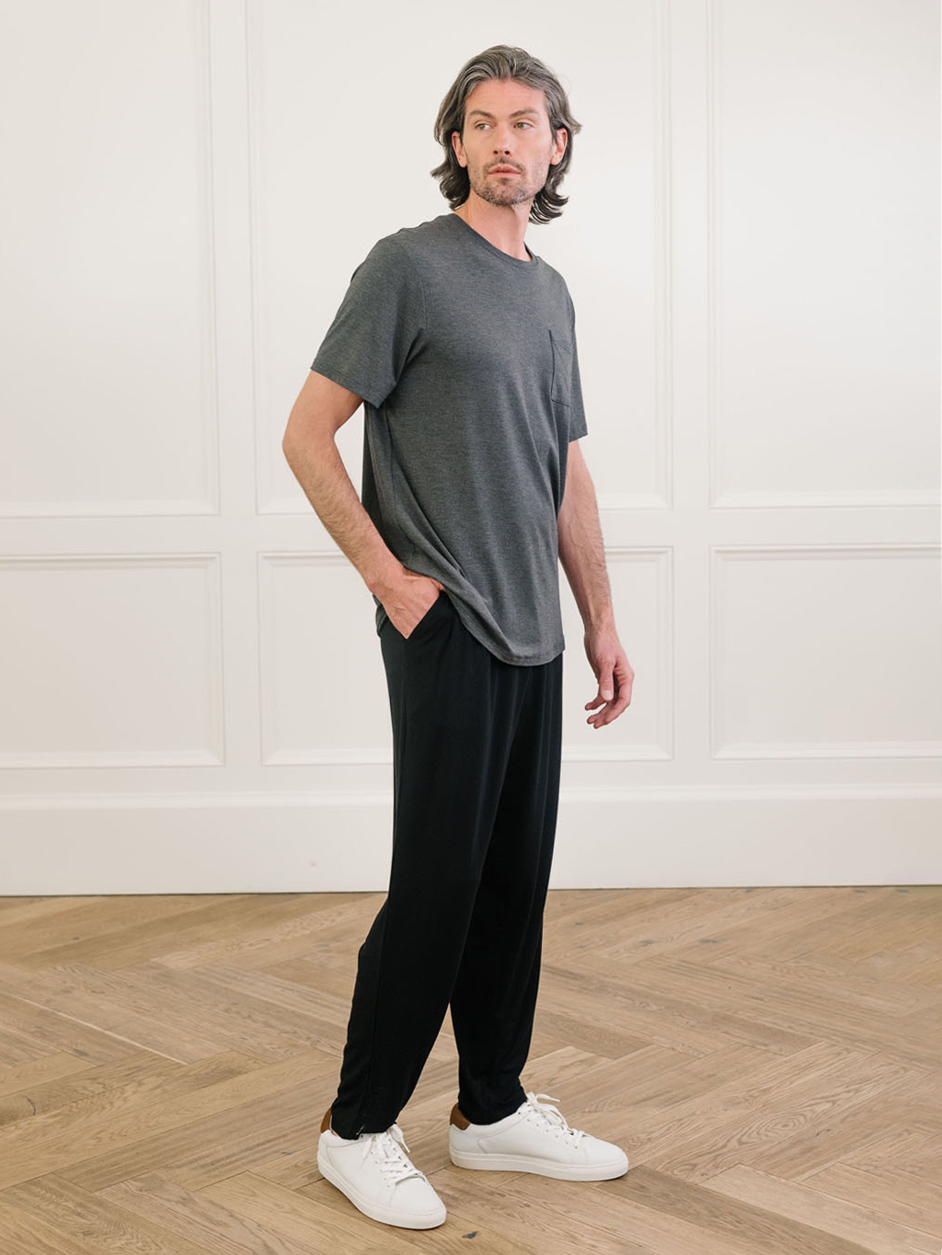 Charcoal Men's Stretch-Knit Bamboo Lounge Tee. A man is wearing the lounge tee in a well lit home.|Color:Charcoal