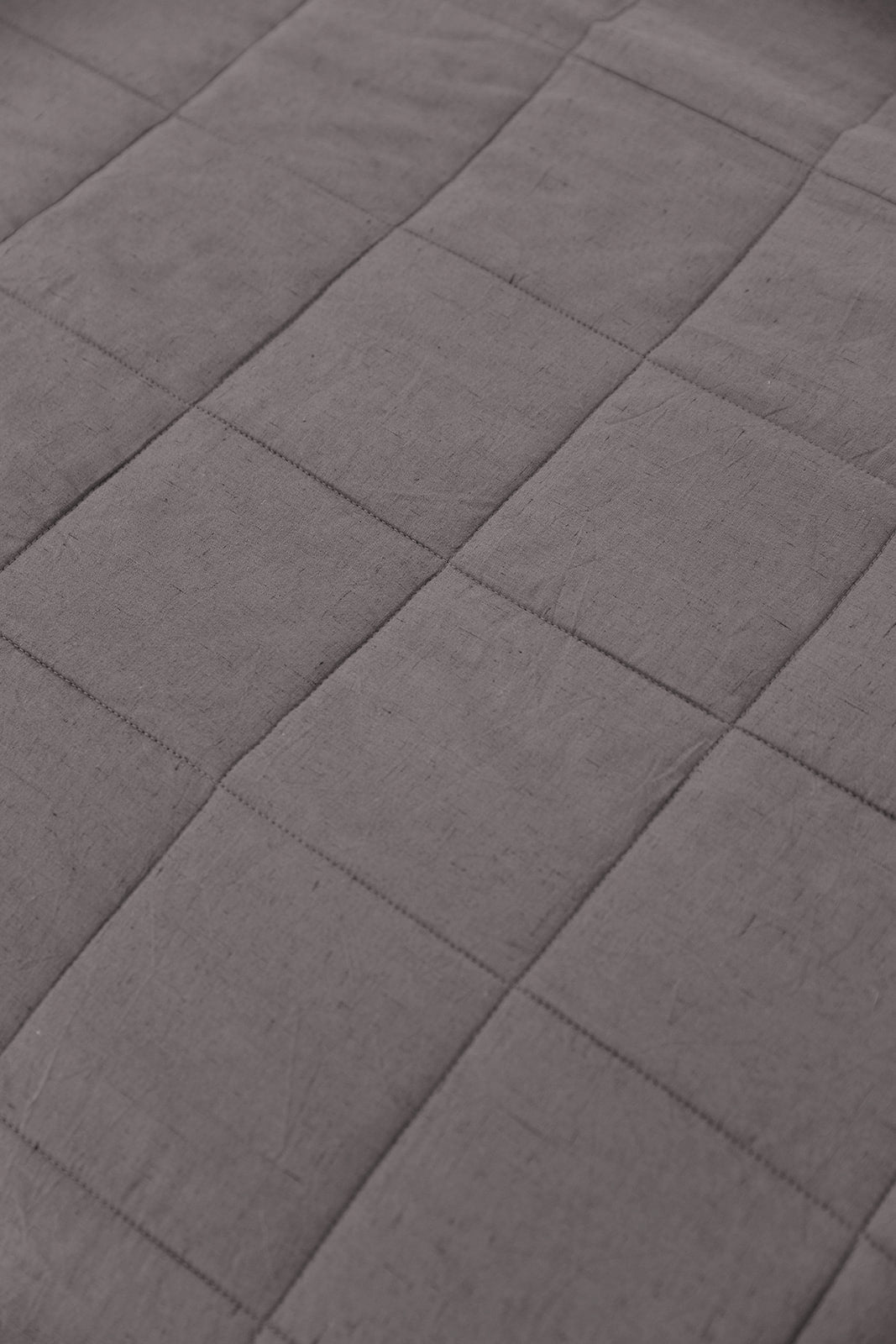 Close up of Charcoal Linen Box Quilt Sham laying flat. 
