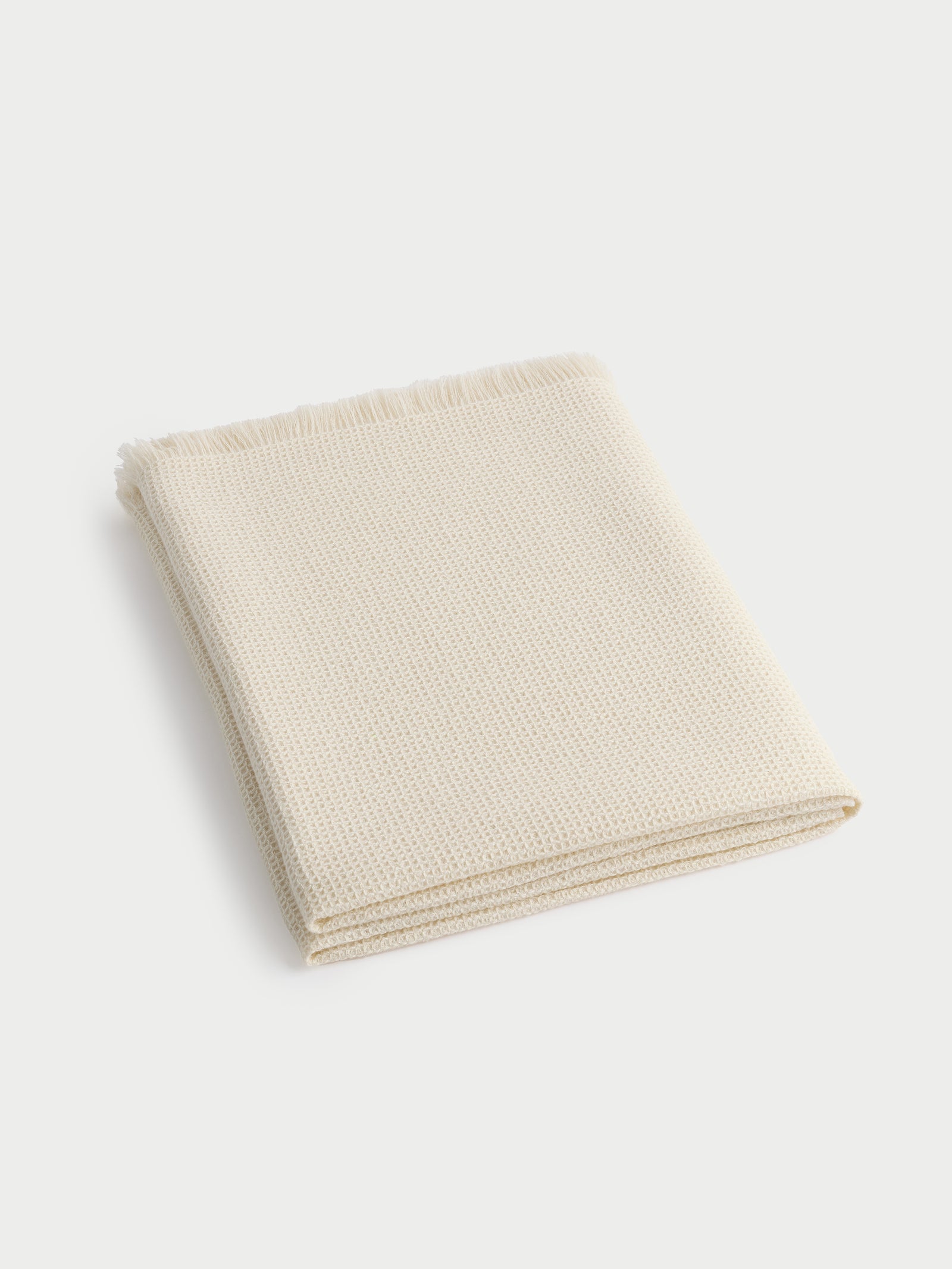 Creme alpaca throw folded with white background 