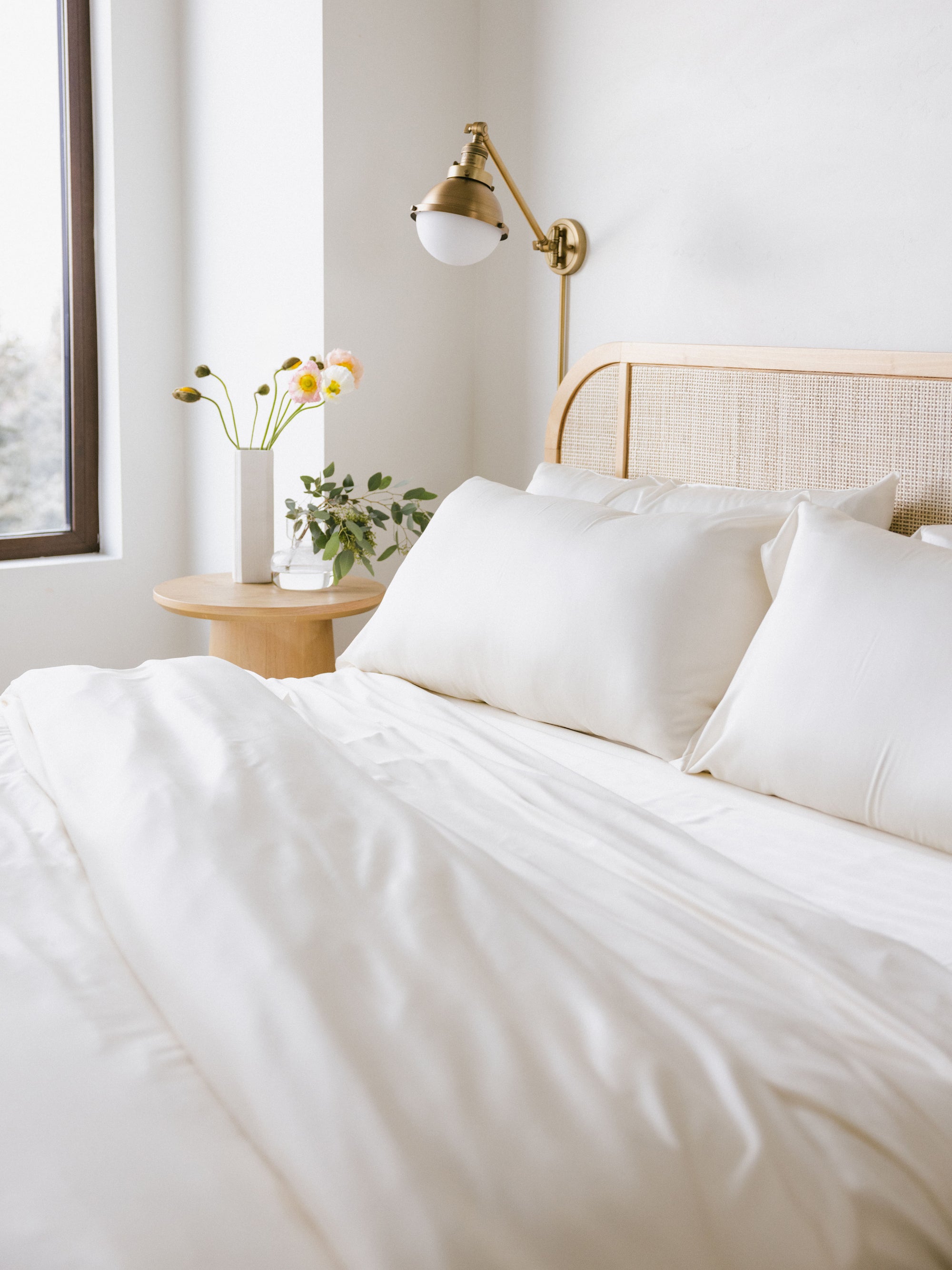 Partially made bed with creme bedding standard/king/body 