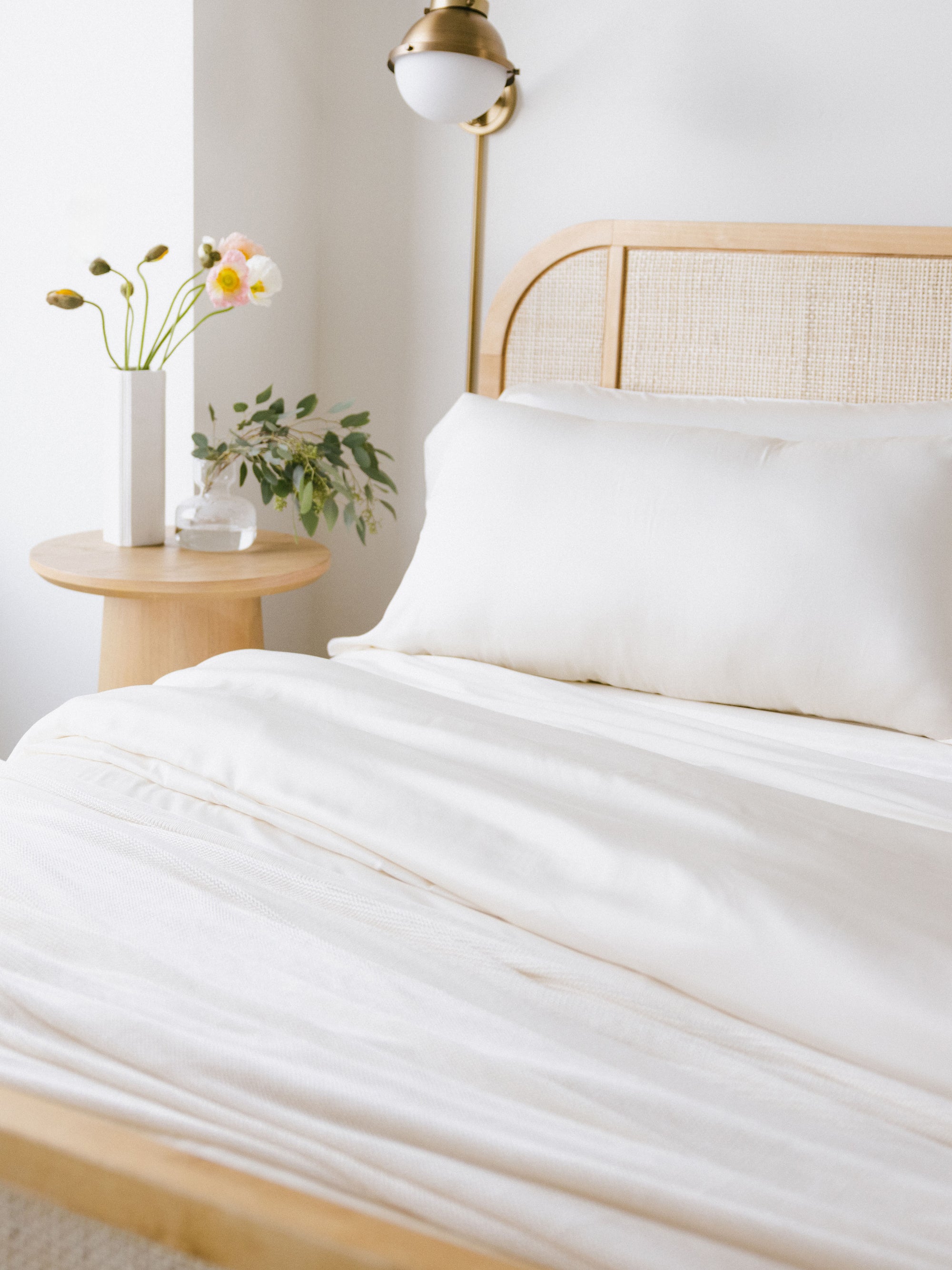 Bed made with creme bedding 