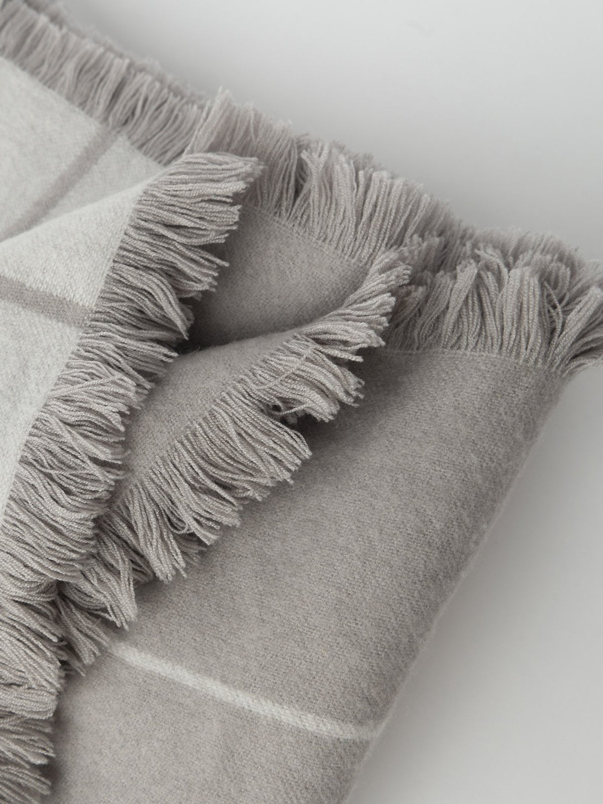 Close up of tasseled edge on grey windowpane blanket |Color:Dove Grey/Light Grey