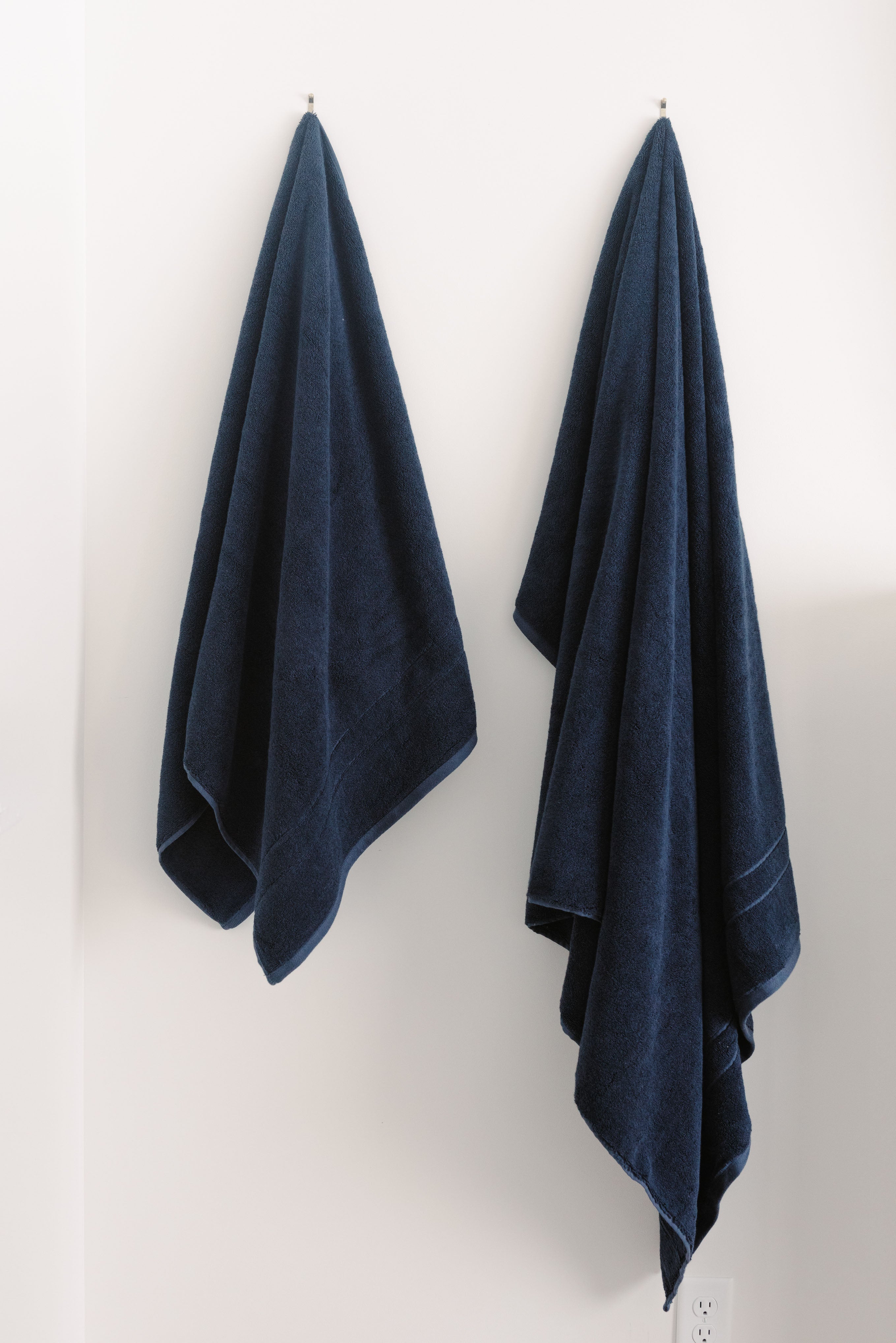 Premium Plush Bath Towels/sheets in the color dusk. Photo of Premium Plush Bath Towels taken in a bathroom showing the towels which are hung from a towel rack. |Color:Dusk