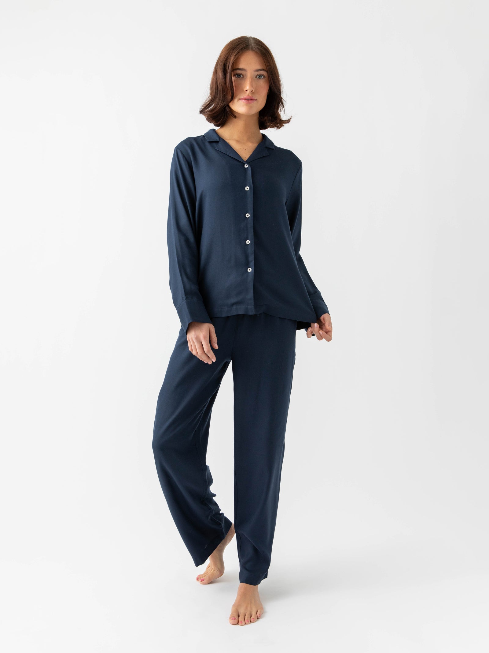 Woman wearing Eclipse soft woven pajamas with white background 