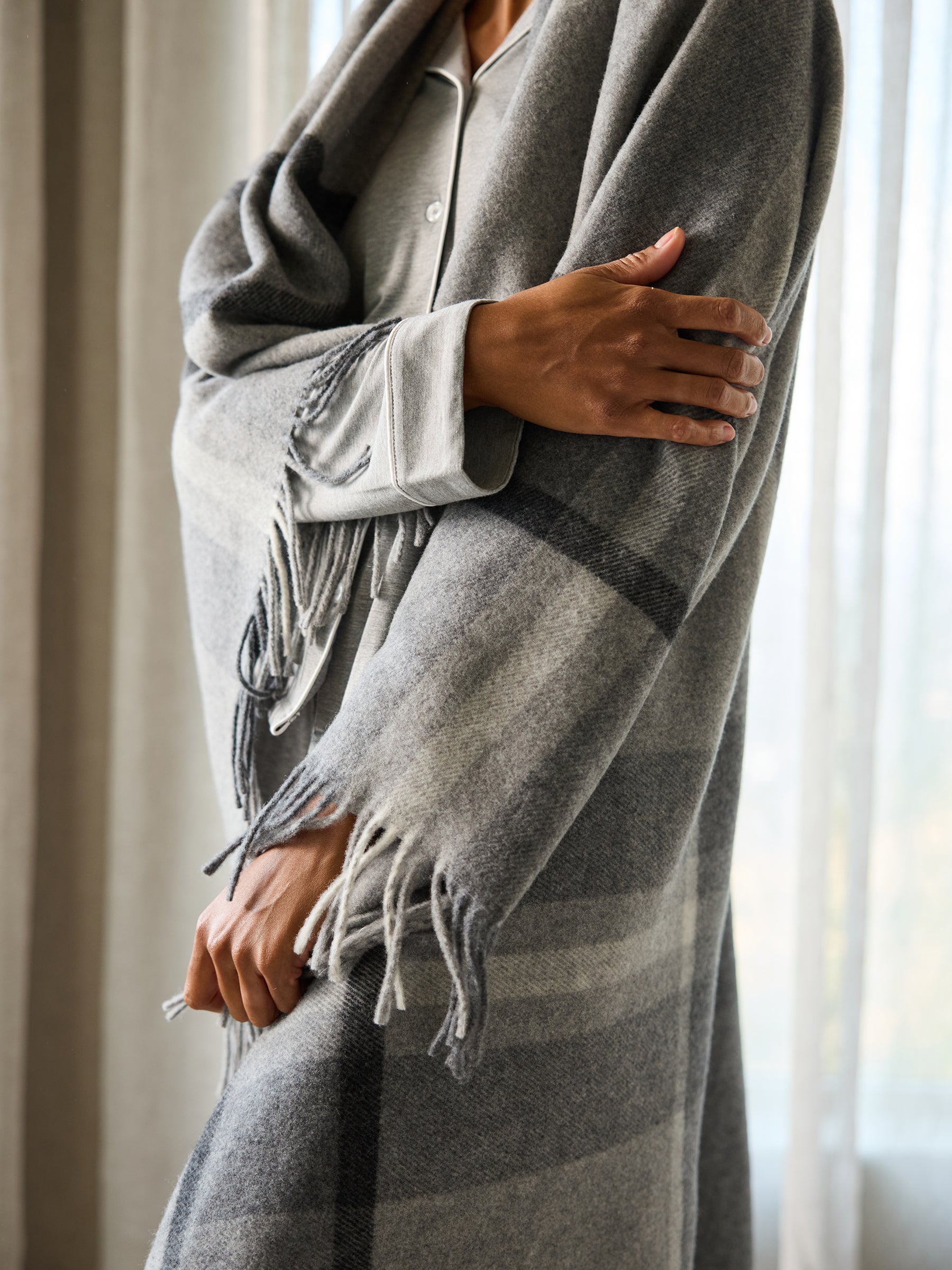 Grey lucca throw wrapped aroound woman 