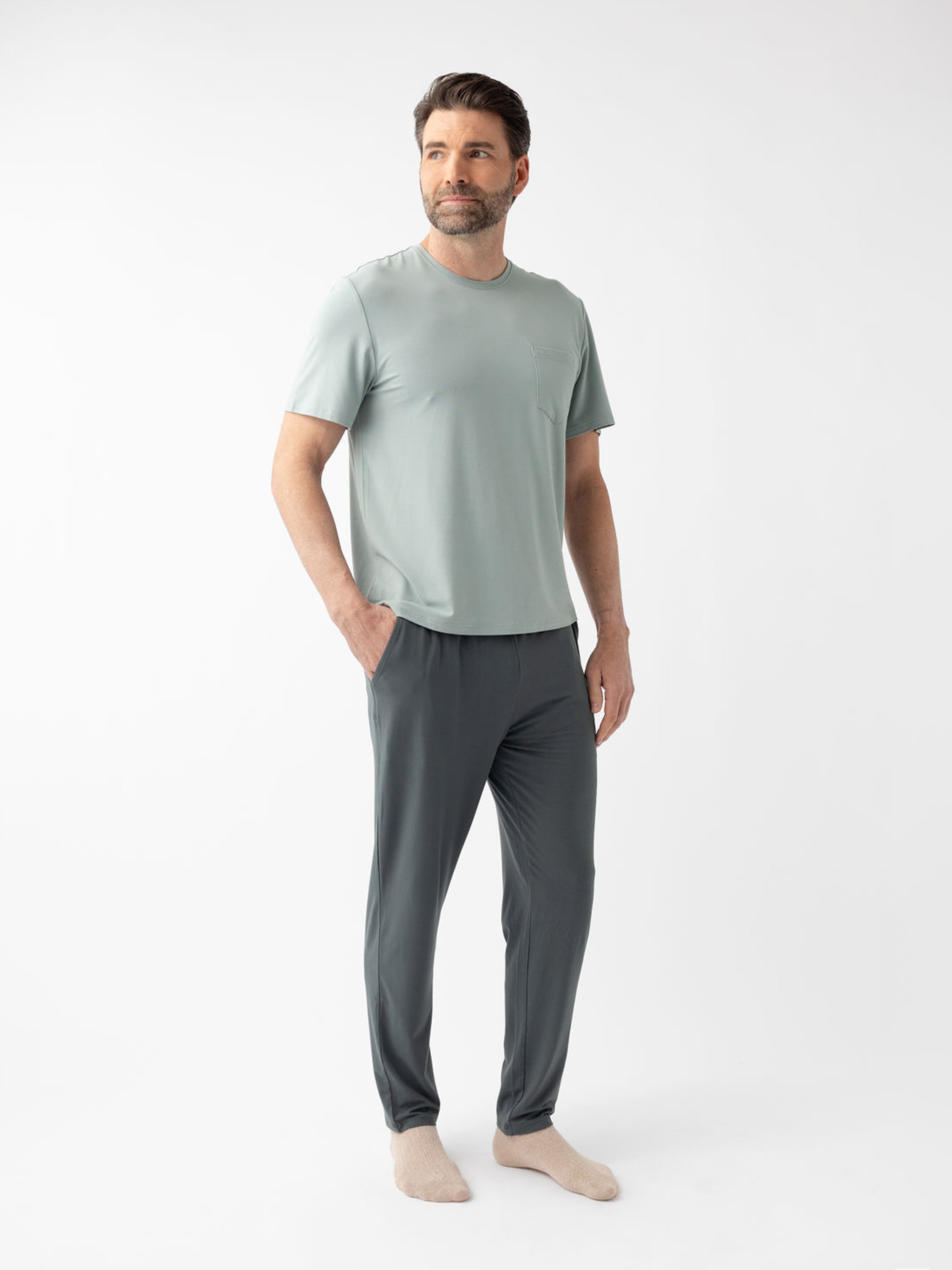 Man wearing storm pajama pants and haze pajama shirt with white background 