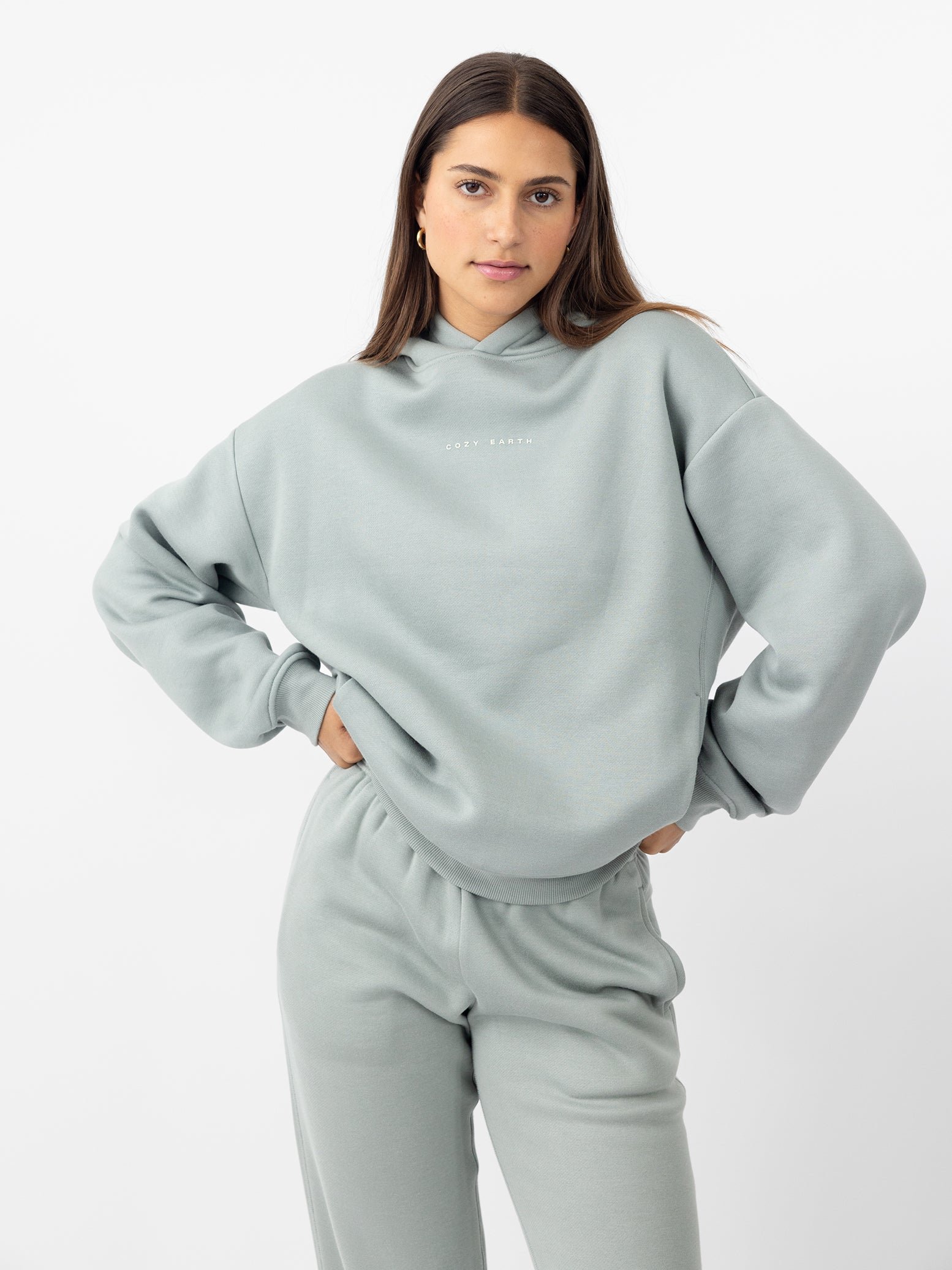 Woman wearing haze cityscape hoodie with white background 