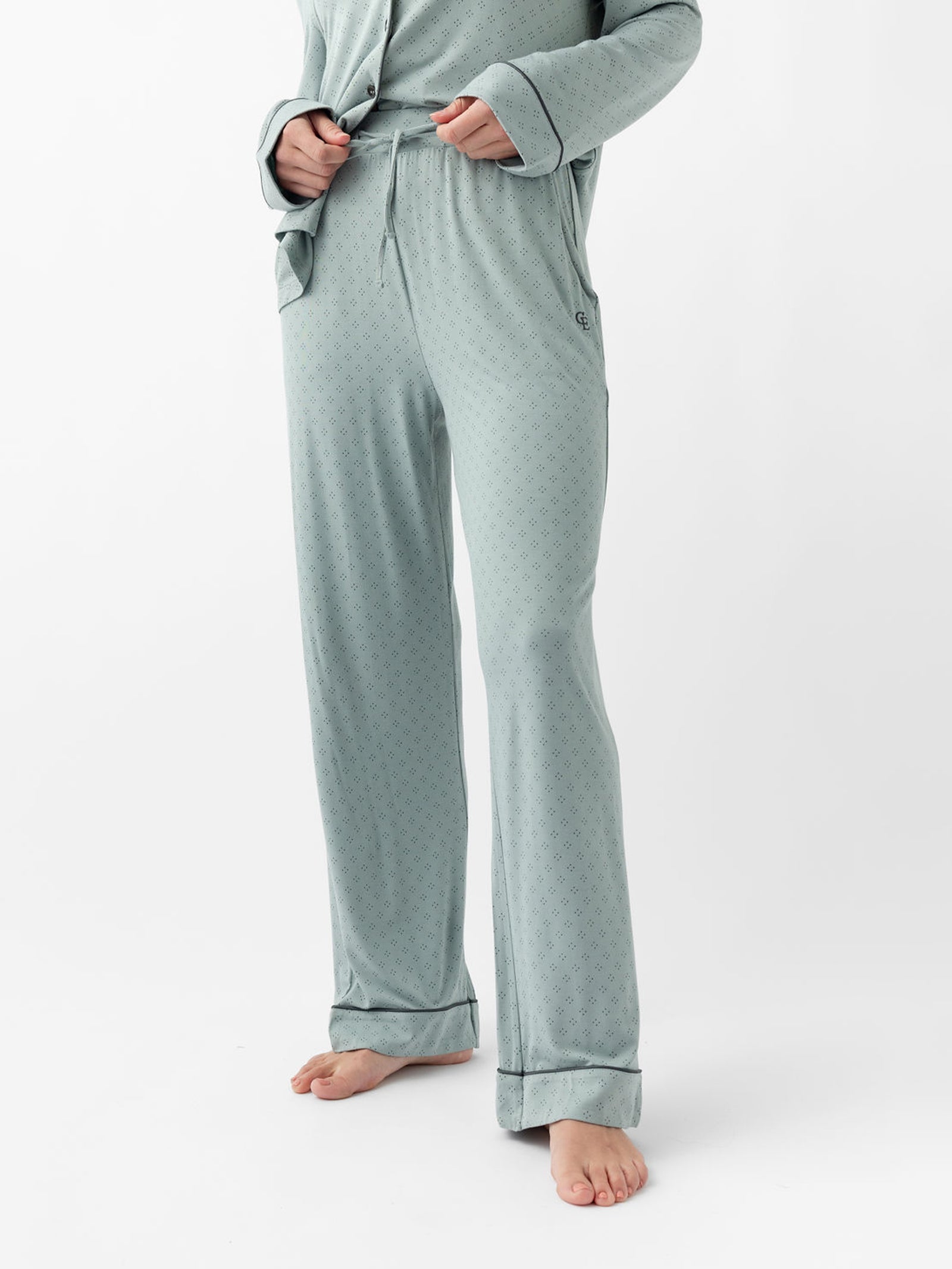 Woman wearing haze diamond dot pajamas pants with white background 