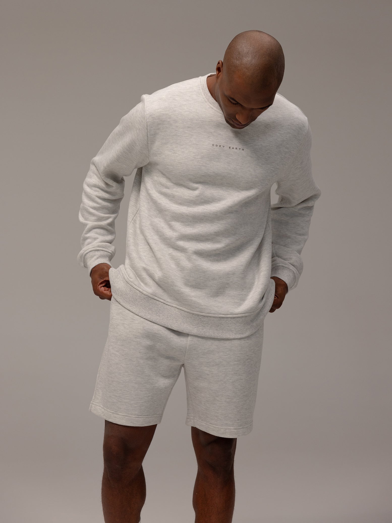 Man wearing heather grey cityscape pullover and shorts 
