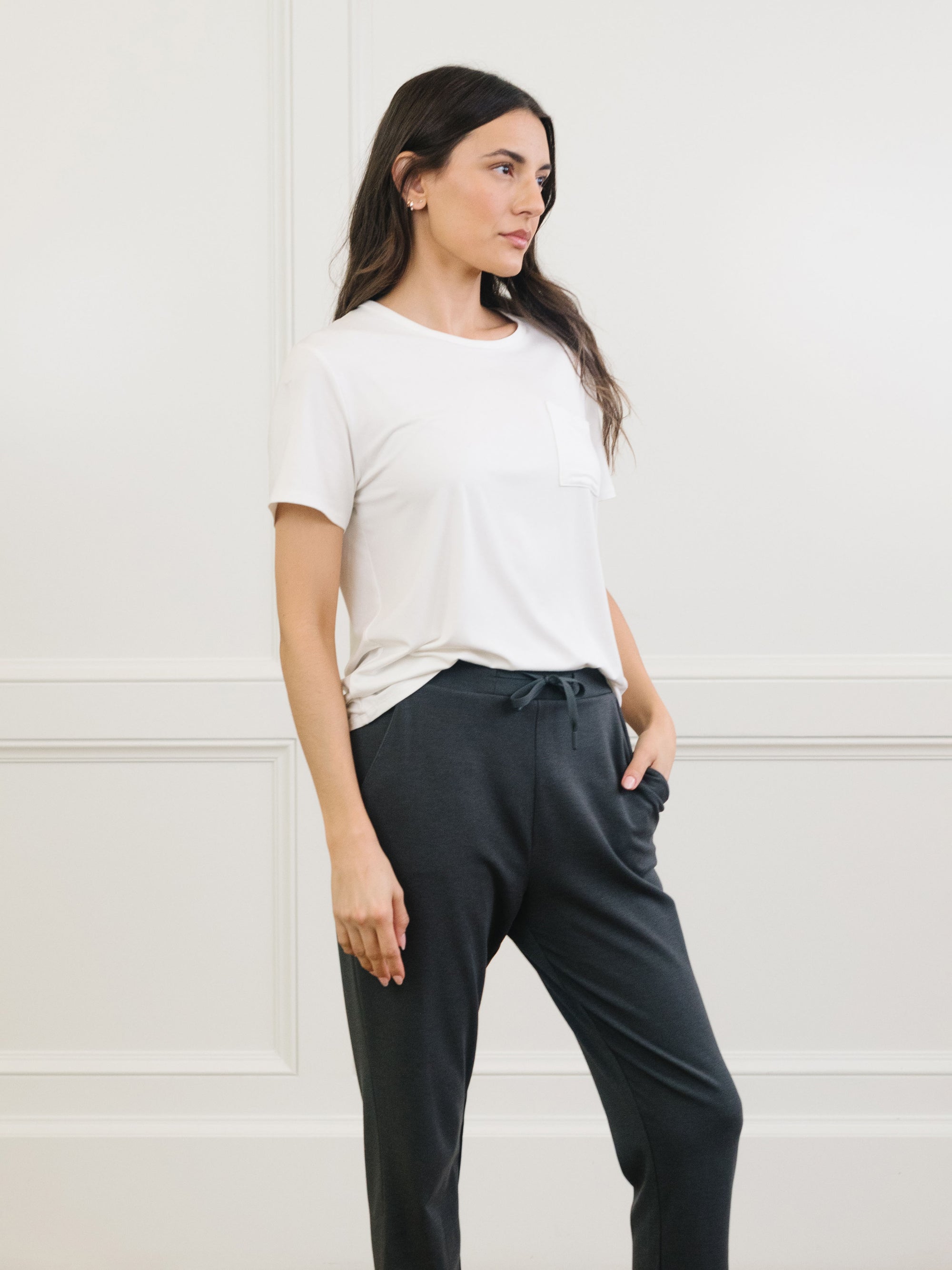 Woman wearing Cozy Earth Bamboo Lounge Tee in ivory faces to the side 