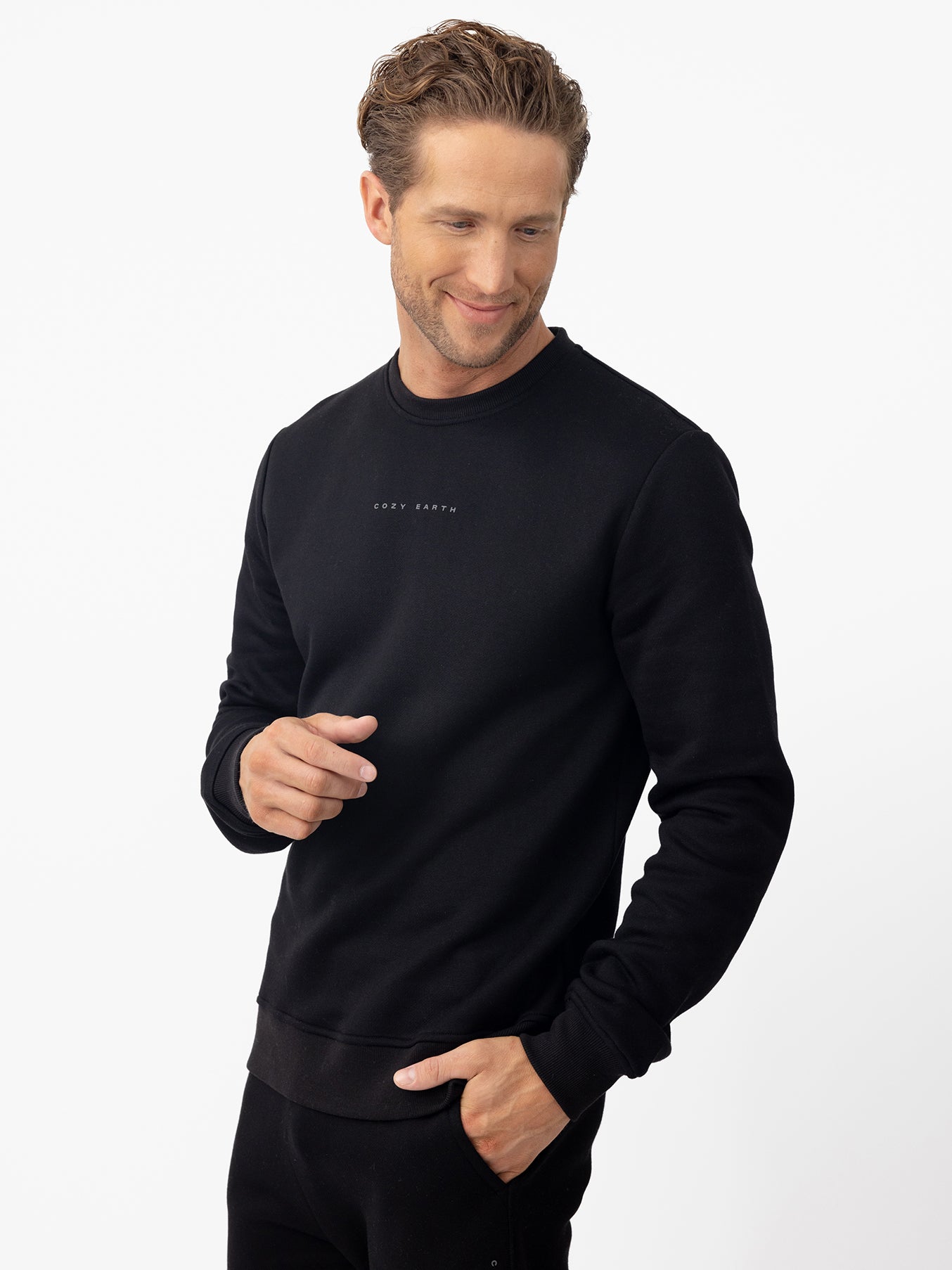Man wearing black cityscape pullover with white background 