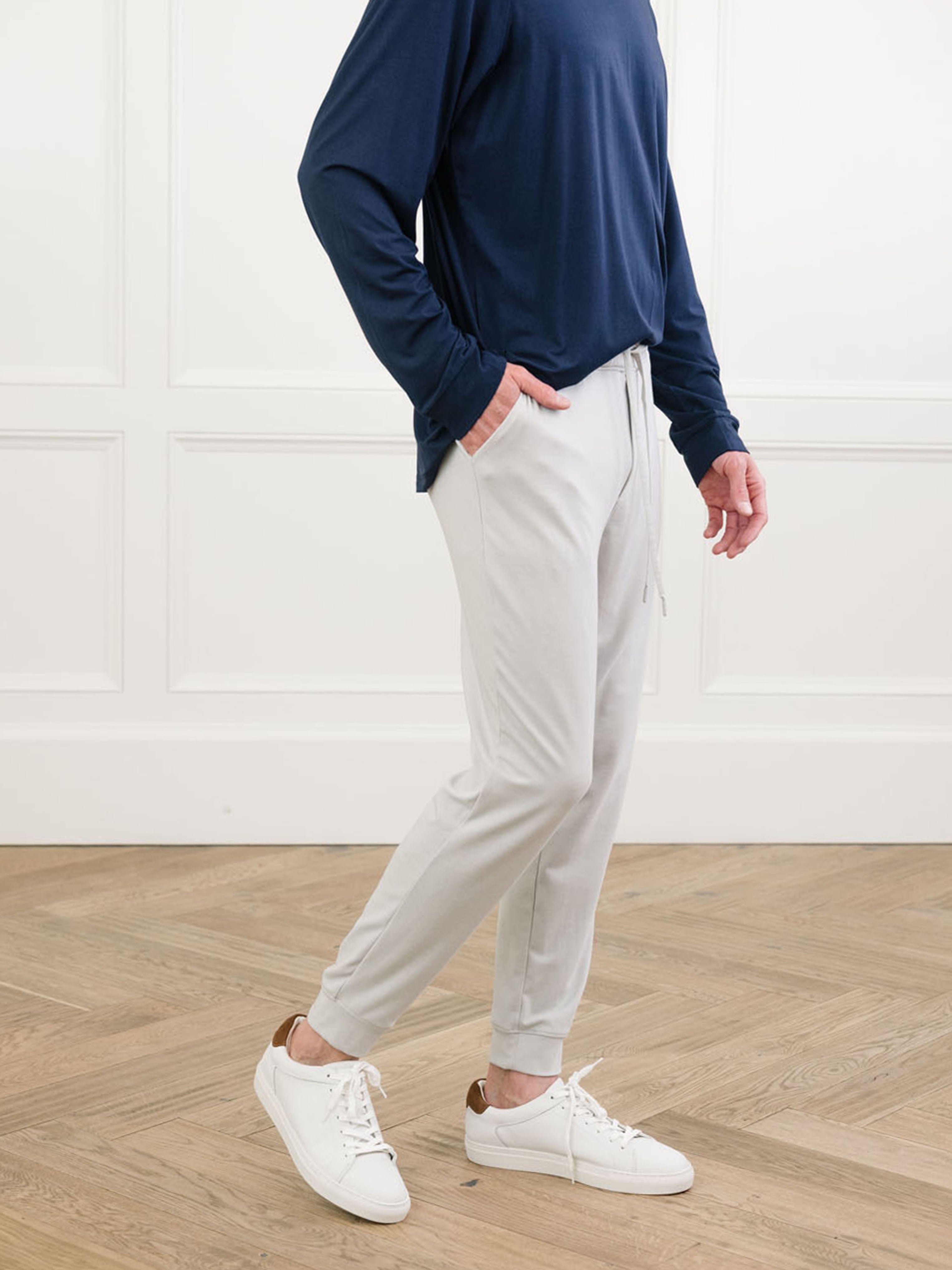 Light Grey/Navy Men's Bamboo Jogger Set. There is a man wearing the jogger set. He is standing in a well lit room in a home.