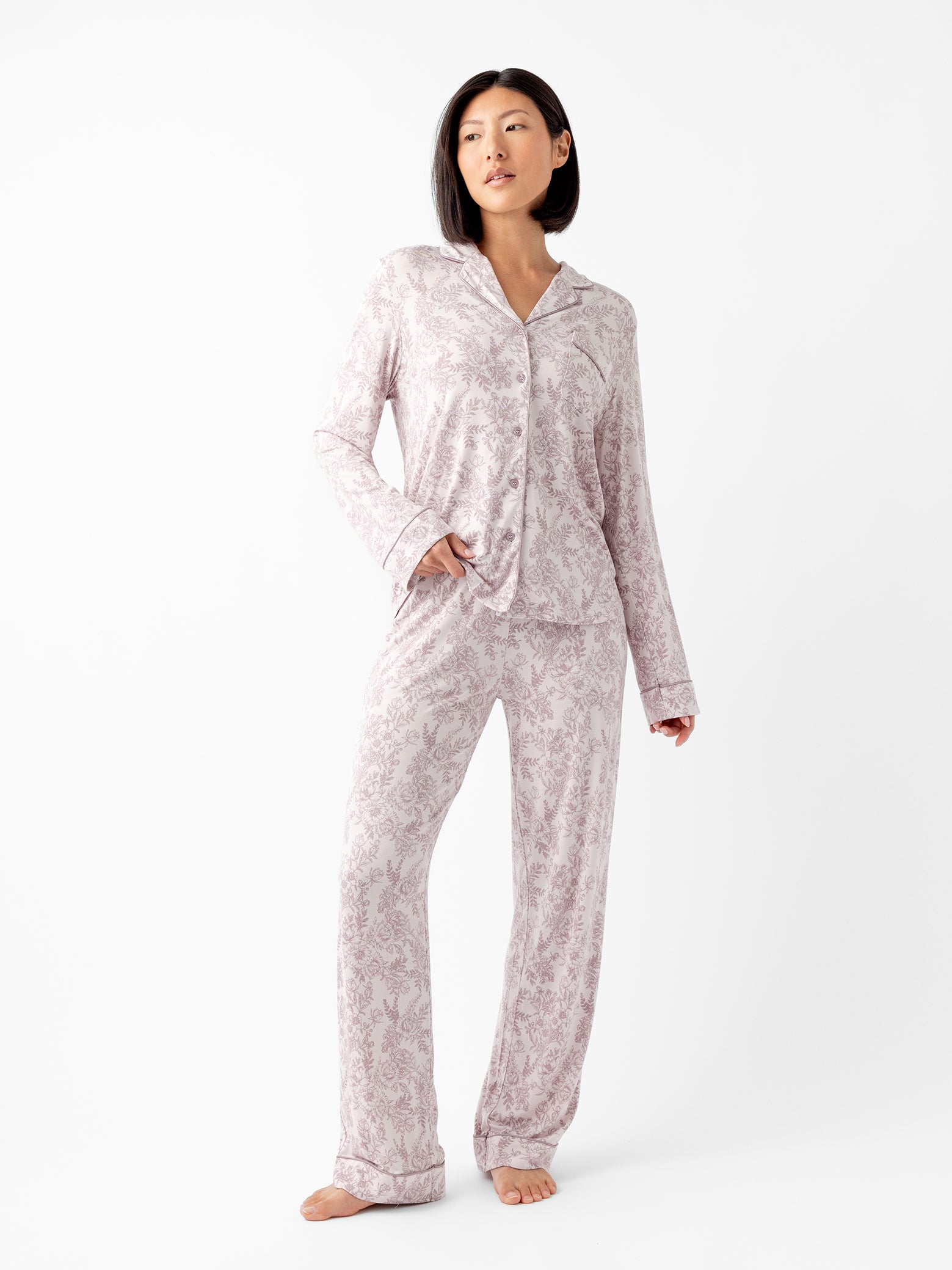 Woman wearing lilac toile pajama set with white background 