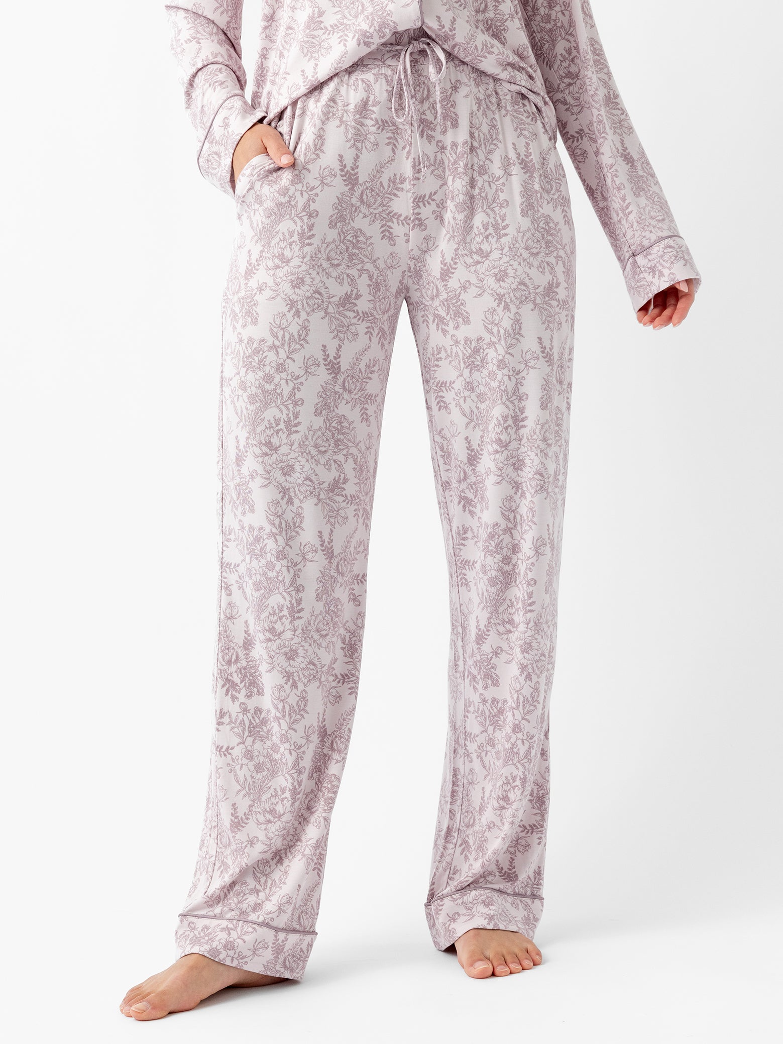 Woman in lilac toile pajama pants with white background 