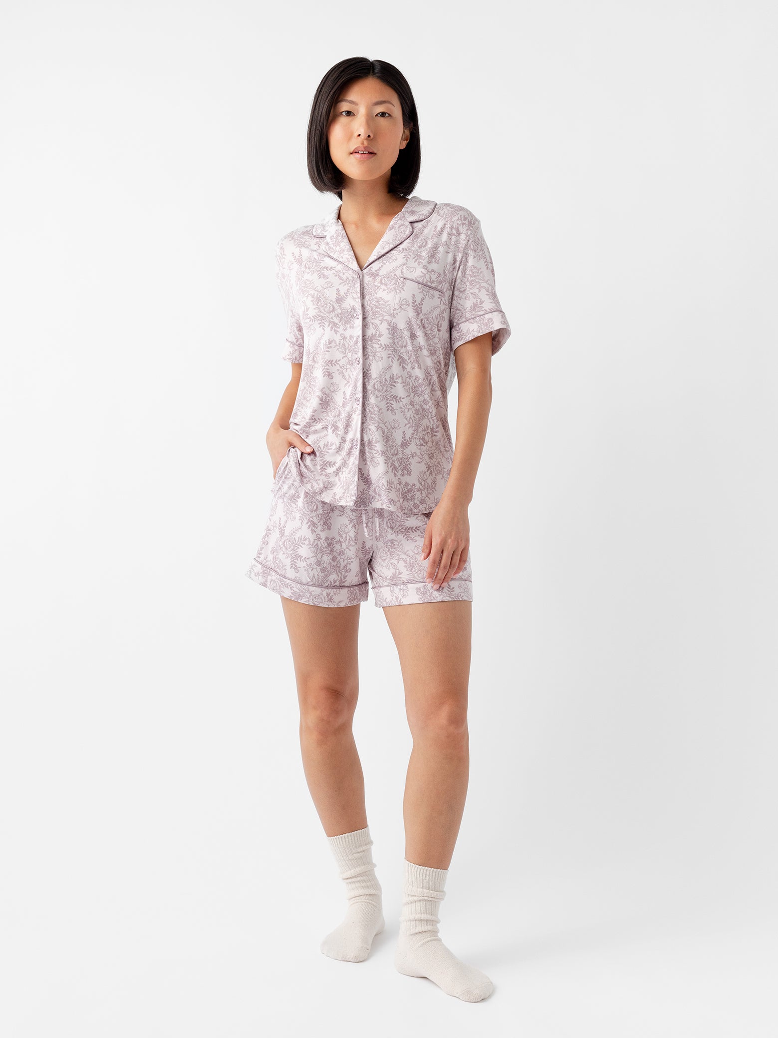 Woman in lilac toile short sleeve pajama set with white background 