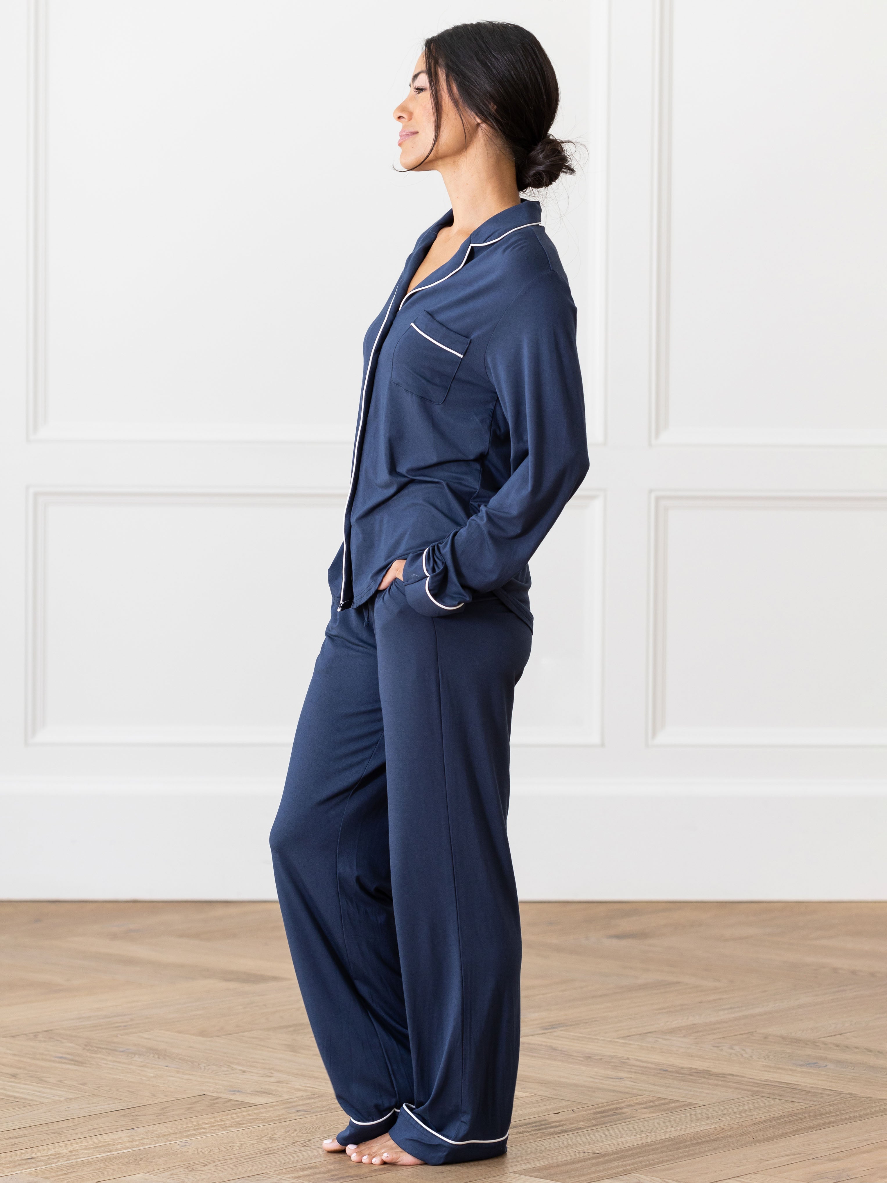 Navy Long Sleeve Pajama Set modeled by a woman. The photo was taken in a high contrast setting, showing off the colors and lines of the pajamas. |Color:Navy