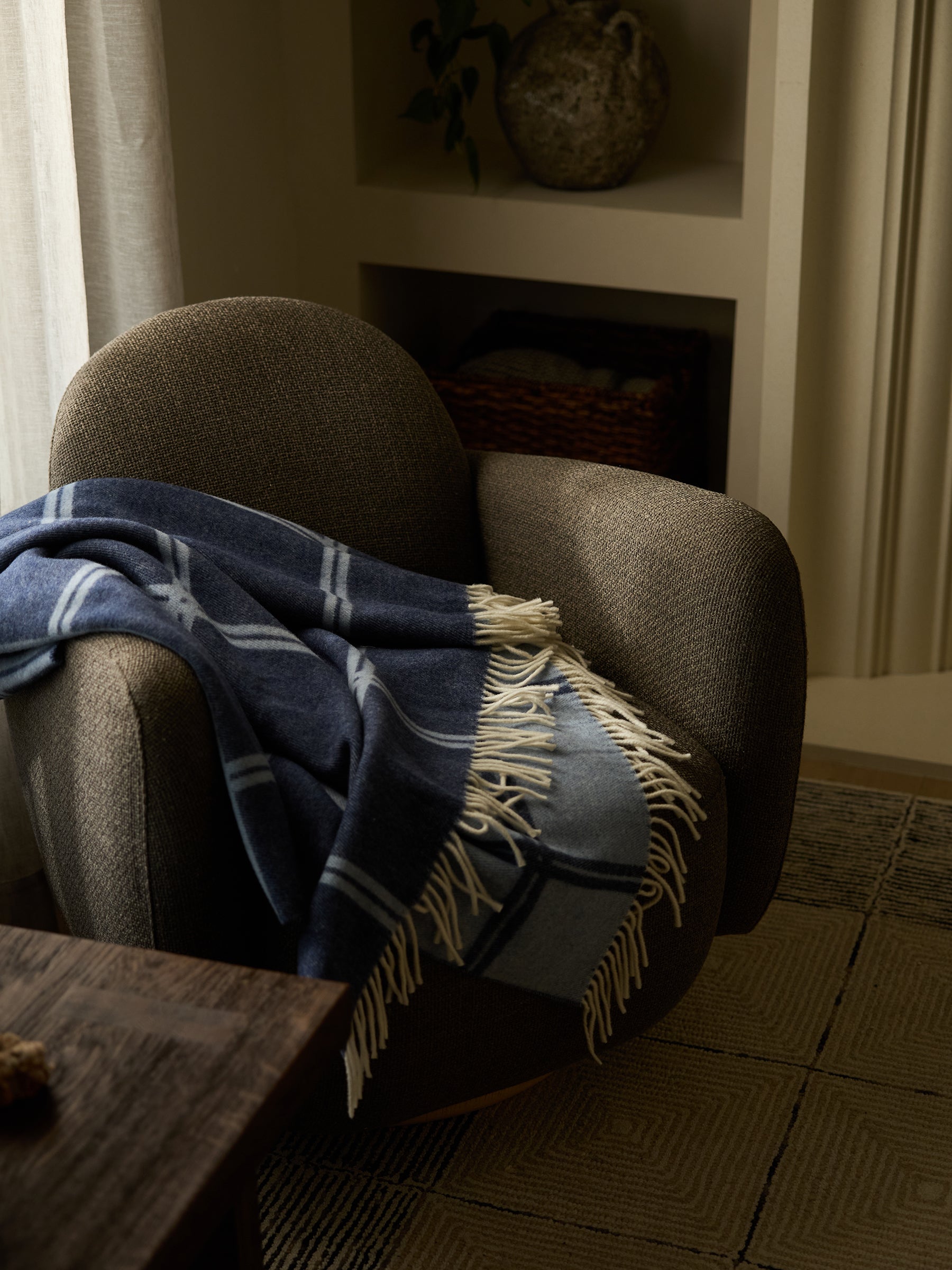 Navy cortina throw laying on recliner |Color:Navy/Sky