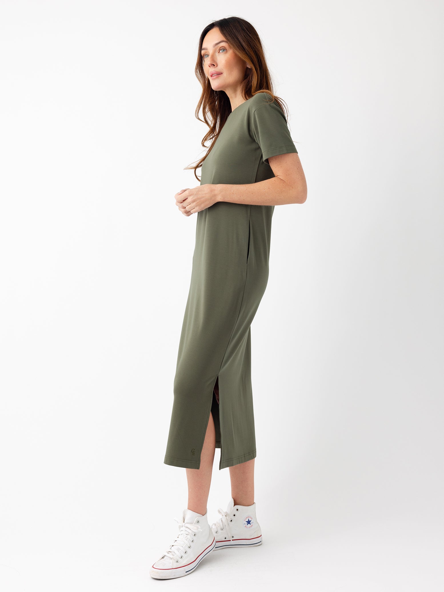 Woman in olive midi dress with white background 