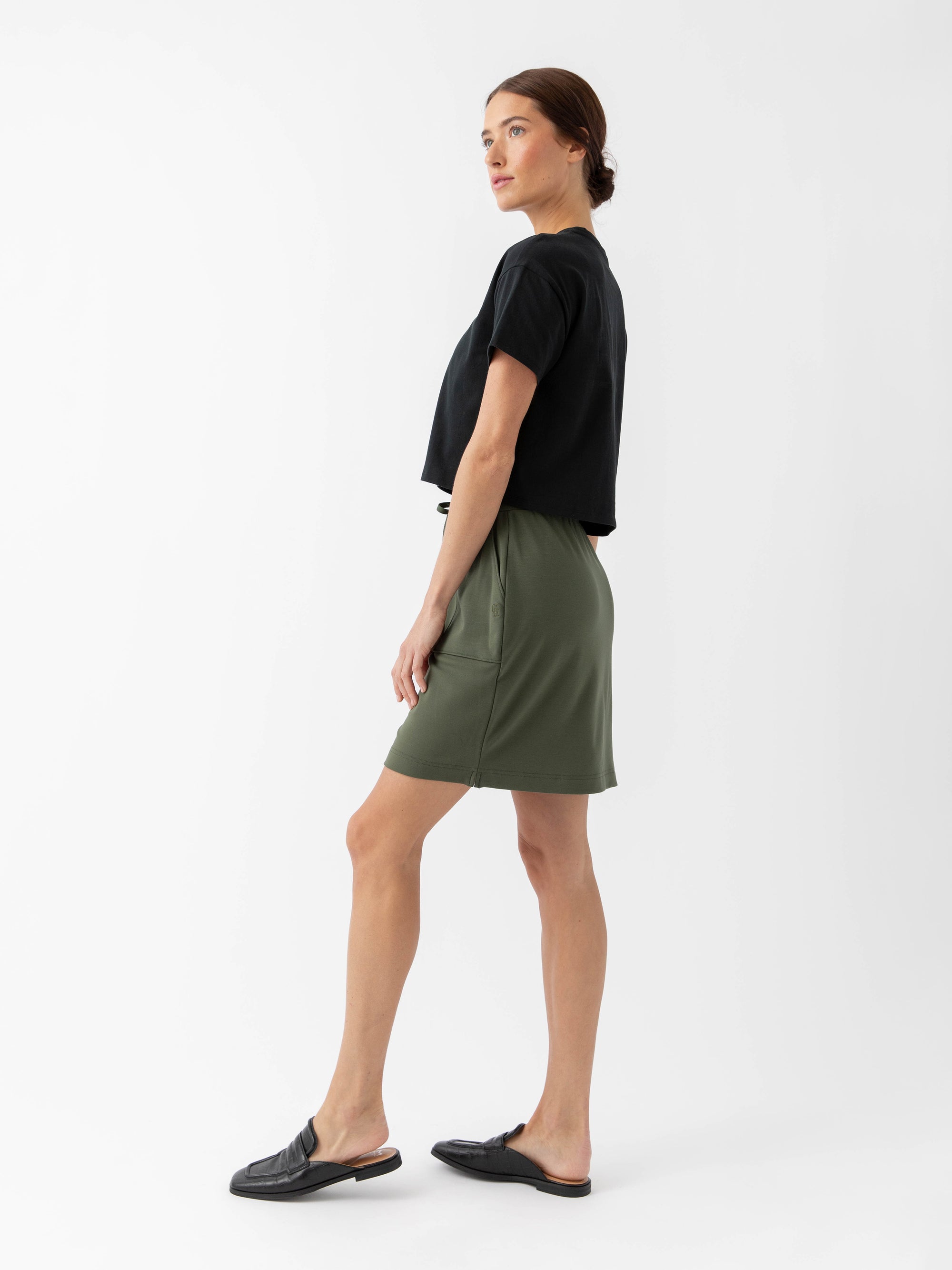 Person wearing a Cozy Earth Brushed Bamboo Patch Pocket Skirt in green on a white background 
