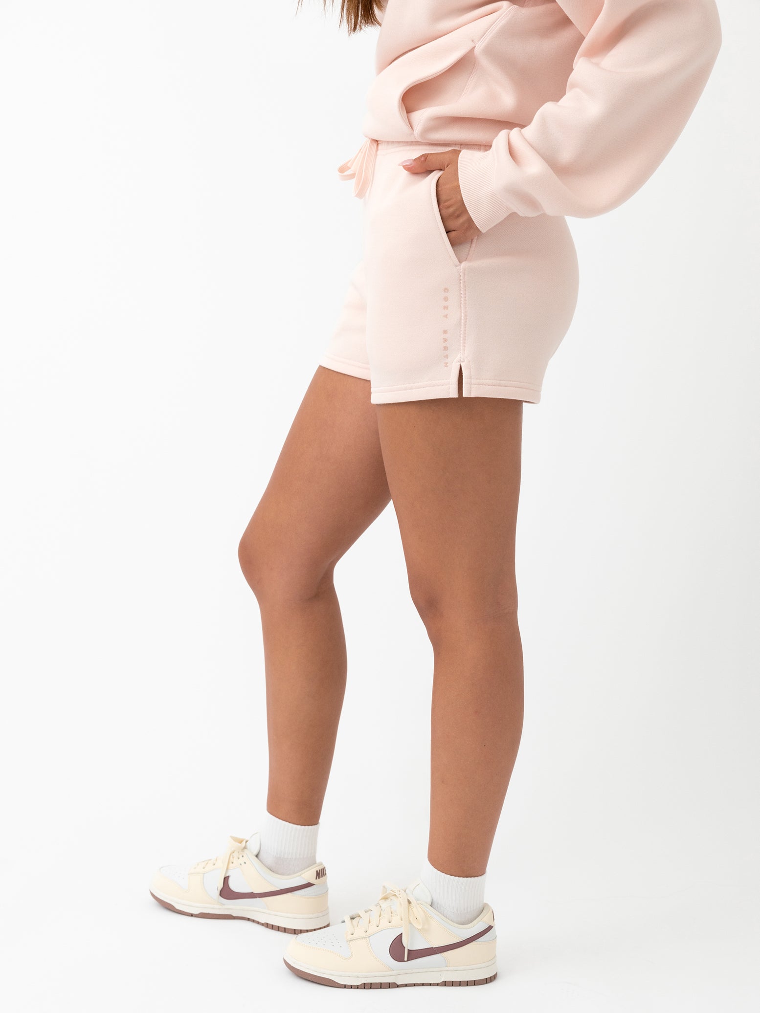 Peony CityScape Shorts. The shorts are being worn by a female model in casual shoes. The background it a white background. 