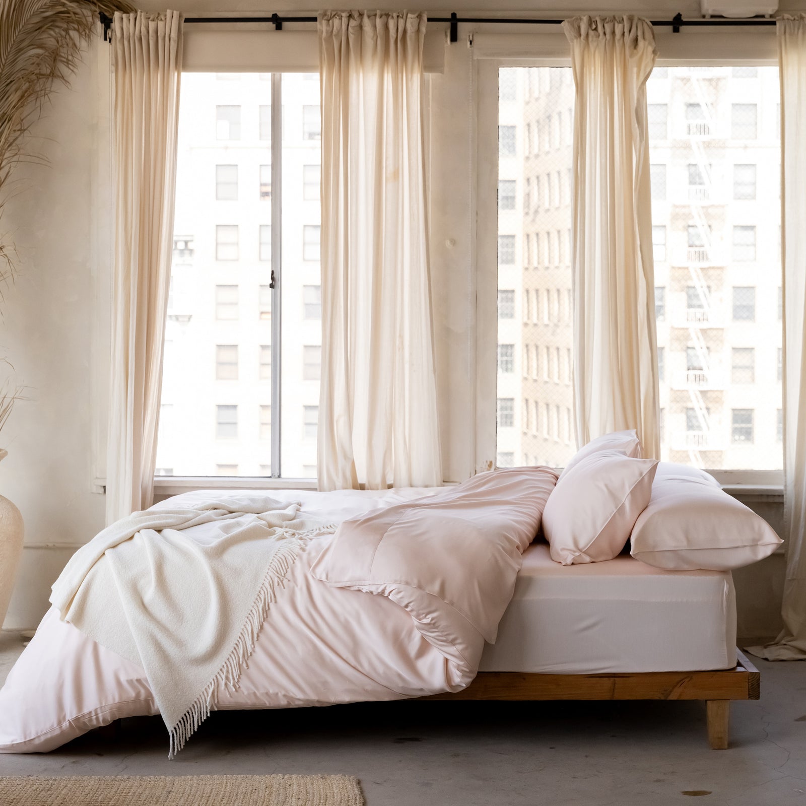 Bed under windows with peony bedding 