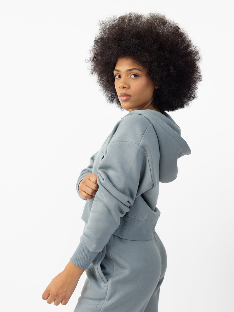 Woman wearing Smokey Blue  CityScape Cropped Full Zip with white background