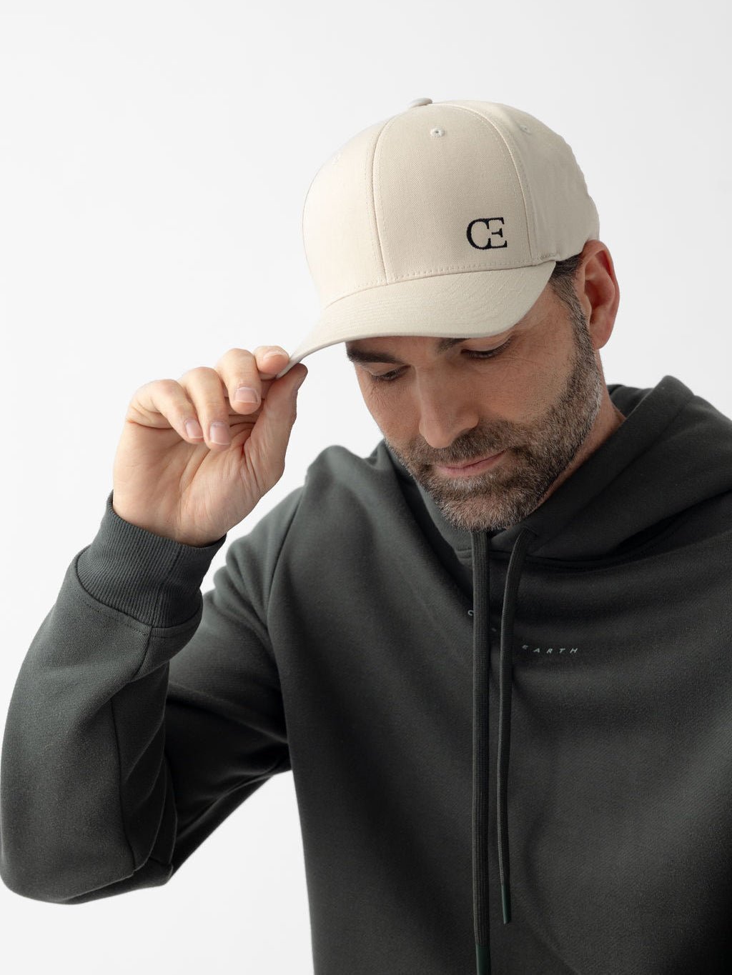 Man wearing stone urban classic hat looking down 