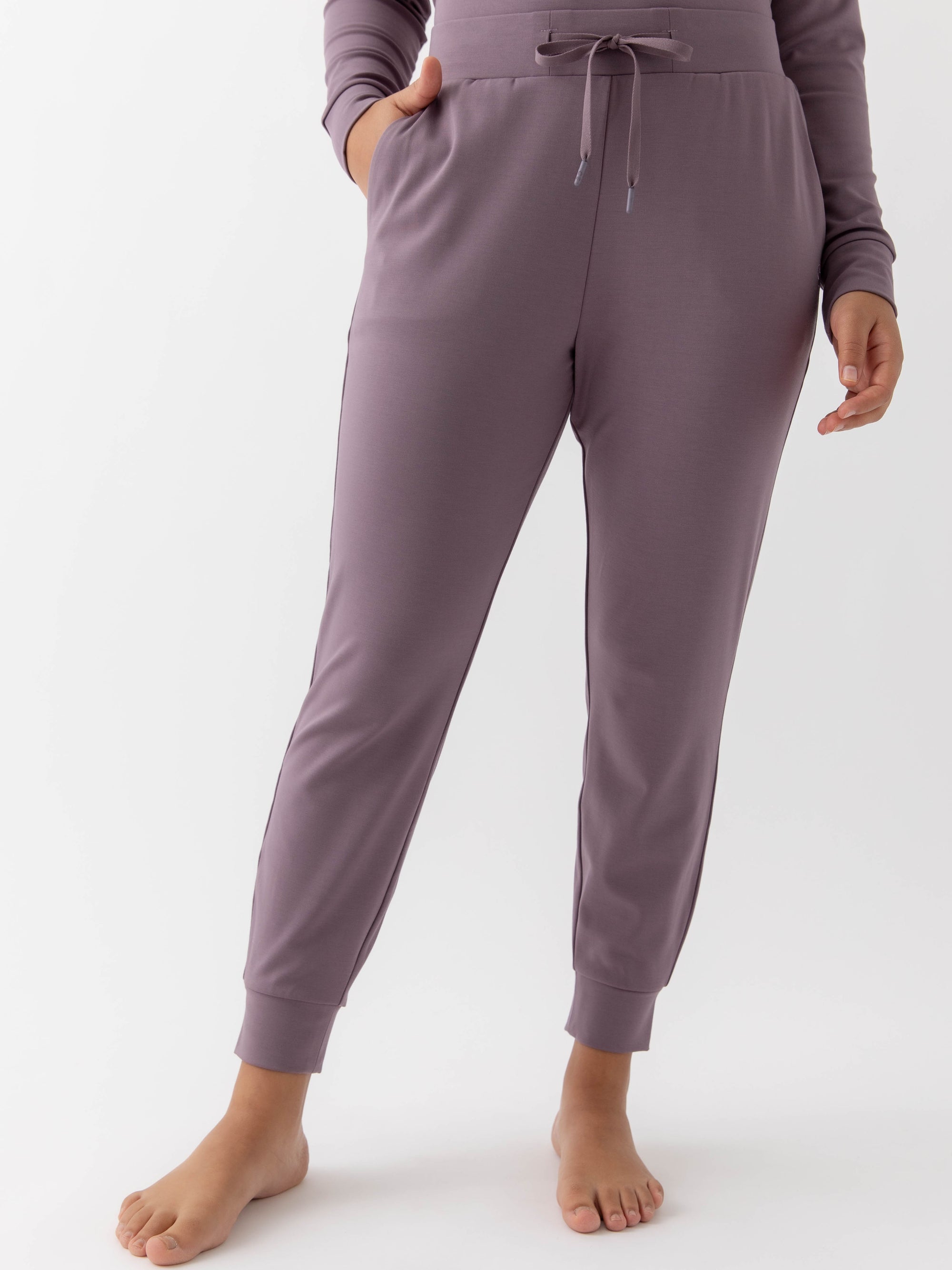 Twilight Bamboo Jogger Set modeled by a woman. The photo was taken in a high contrast setting, showing off the colors and lines of the pajamas. 